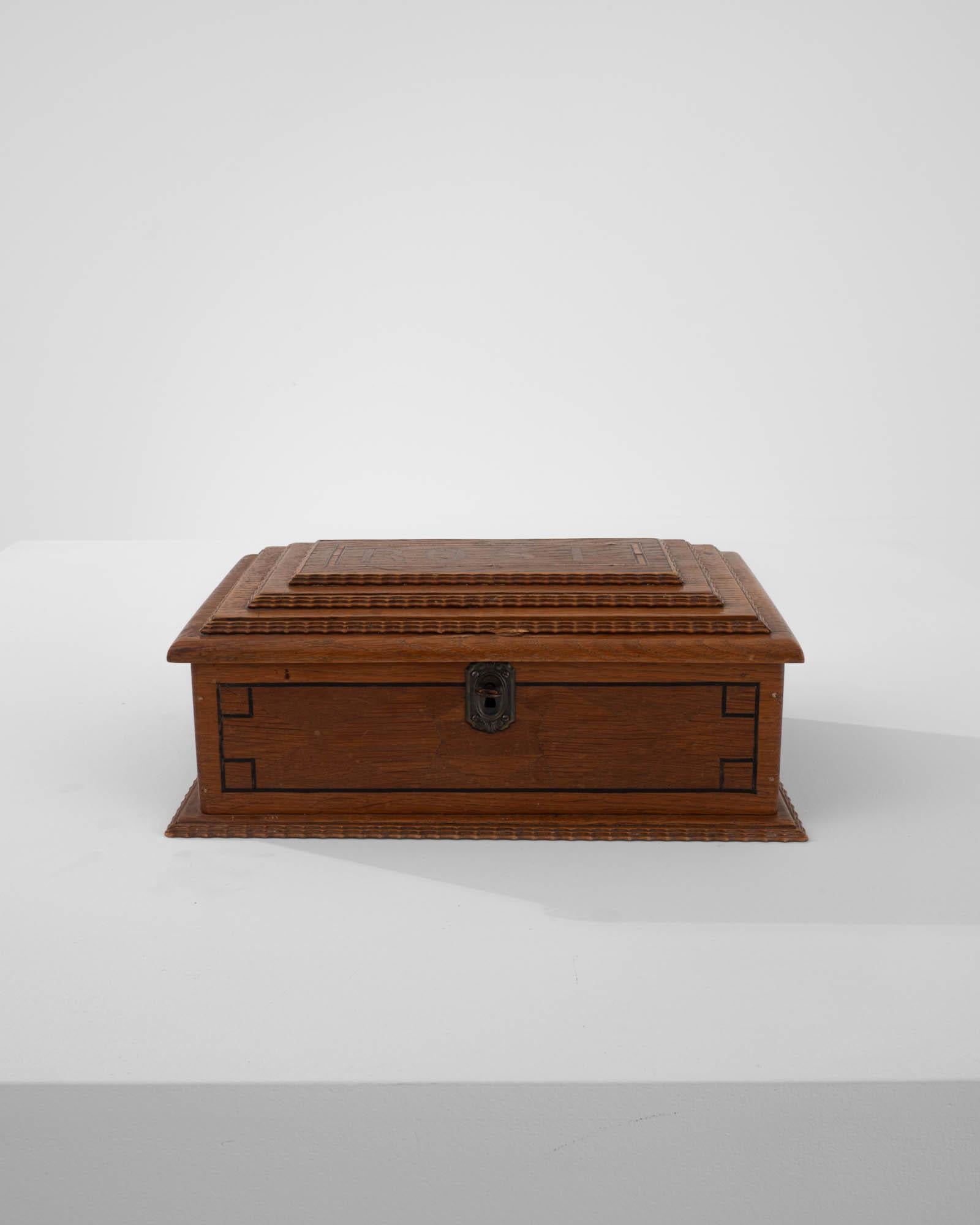 This simple oak jewelry box reveals a surprisingly careful construction, a small lock keeps its contents safe. Inlaid with geometric details, the word “Rose” is carefully pieced together on the box’s lid. Touted through the years, this little