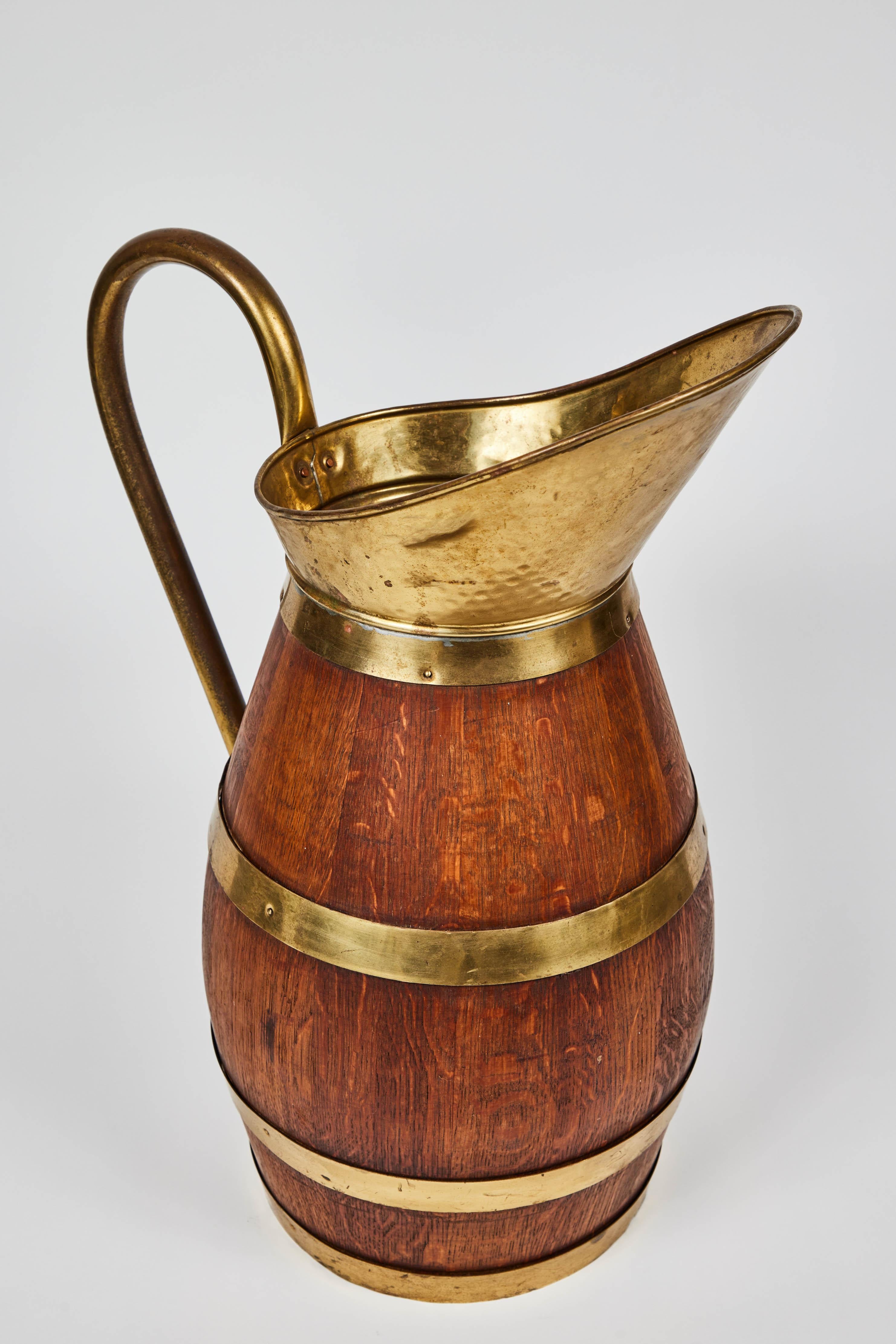 Antique French oak staved and copper-bound wine or cider jugs with copper bands, spout and handles c.1900 -1930. These are made in the same way as the big wine barrels are made.