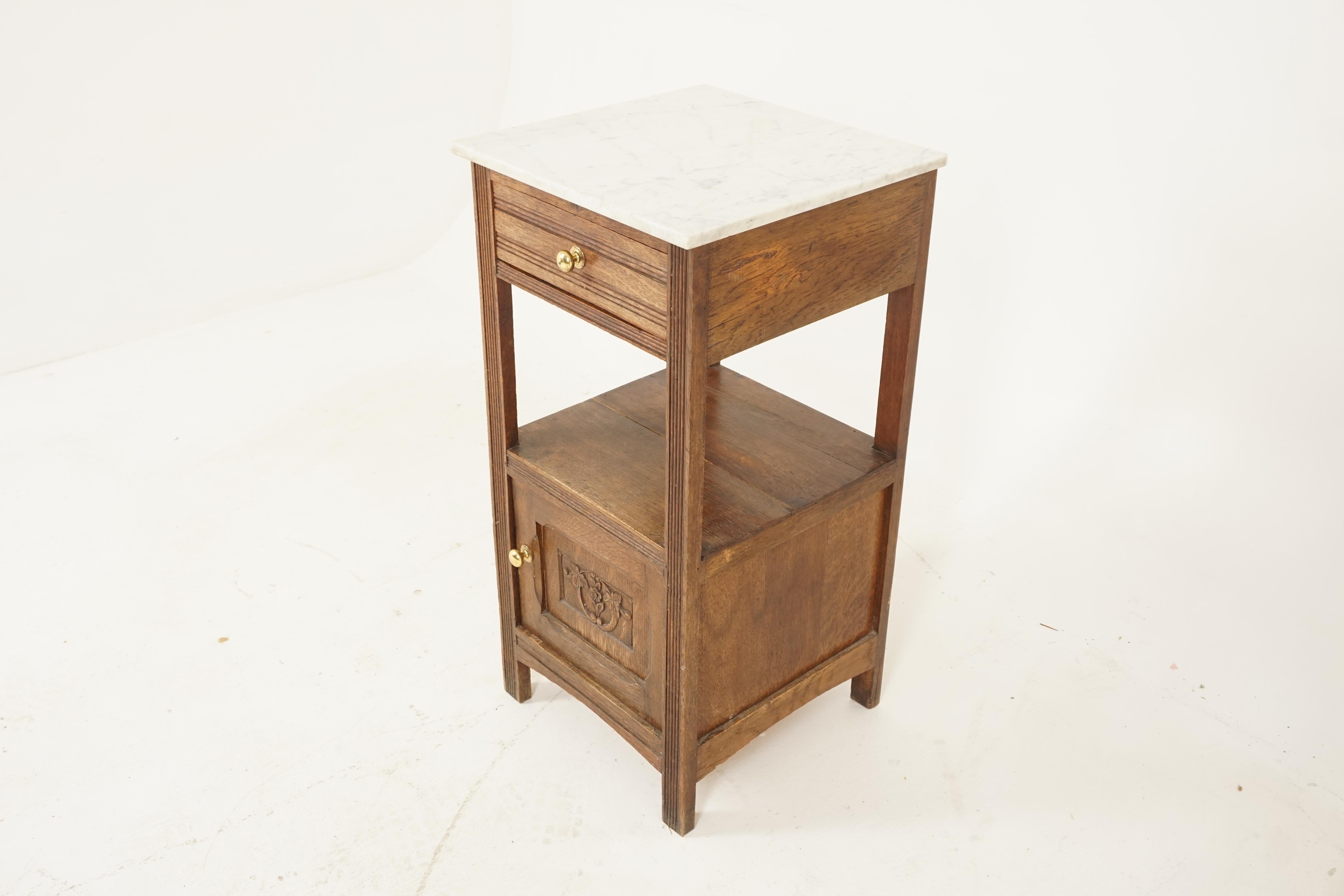 Antique French oak marble top nightstand lamp table, France 1900, B2737

France 1900
Solid oak
Original finish
White marble top
Above a single drawer with brass hardware
Open shelf with a carved cupboard door underneath
Opens to reveal