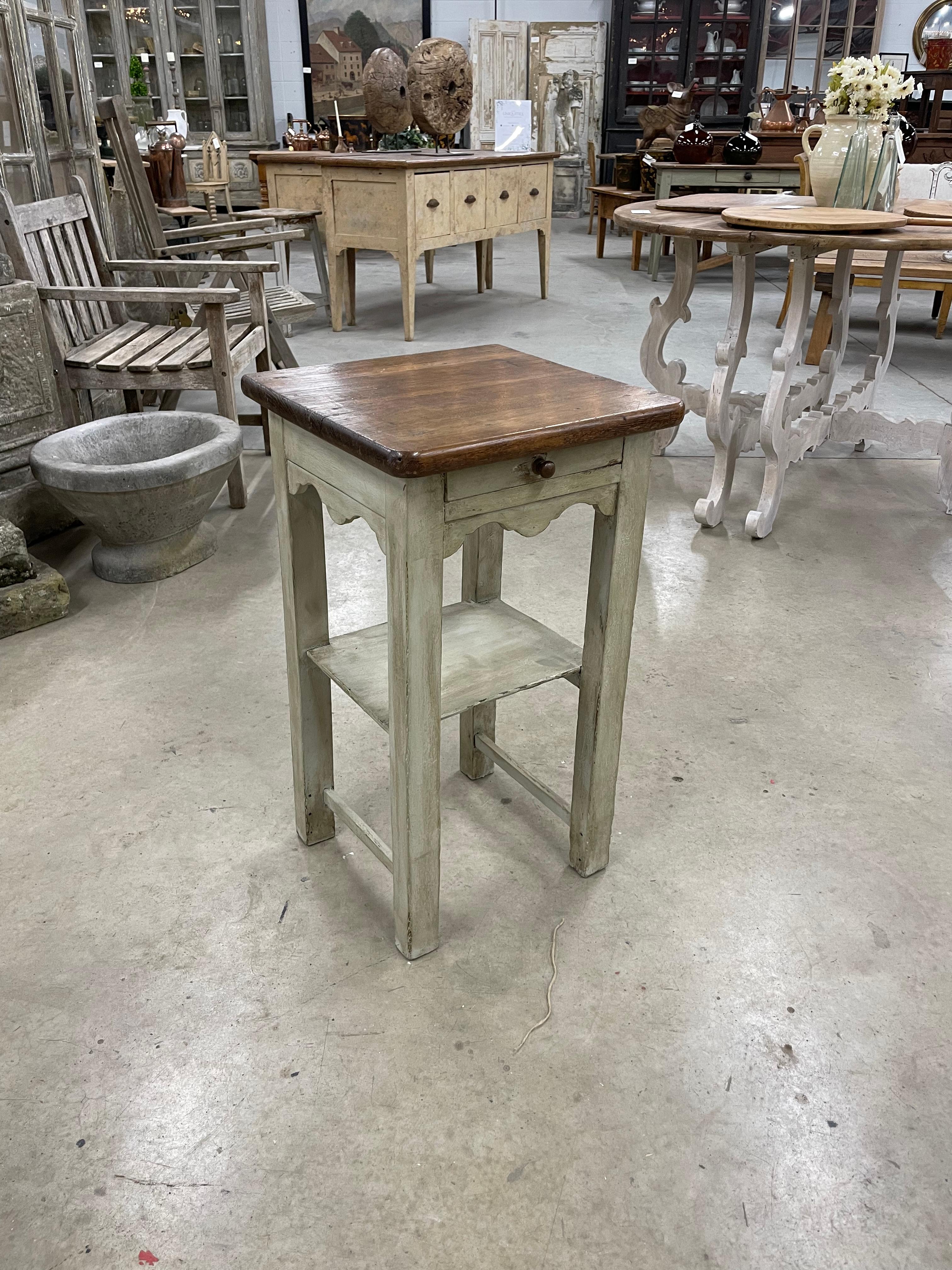 Antique Restauration period single drawer,, single ledge painted side table with scalloped skirt on 4 sides, It’s early construction made with dovetails and peg joints . 

This lovely old French farmhouse table was sourced in Burgundy, France. 