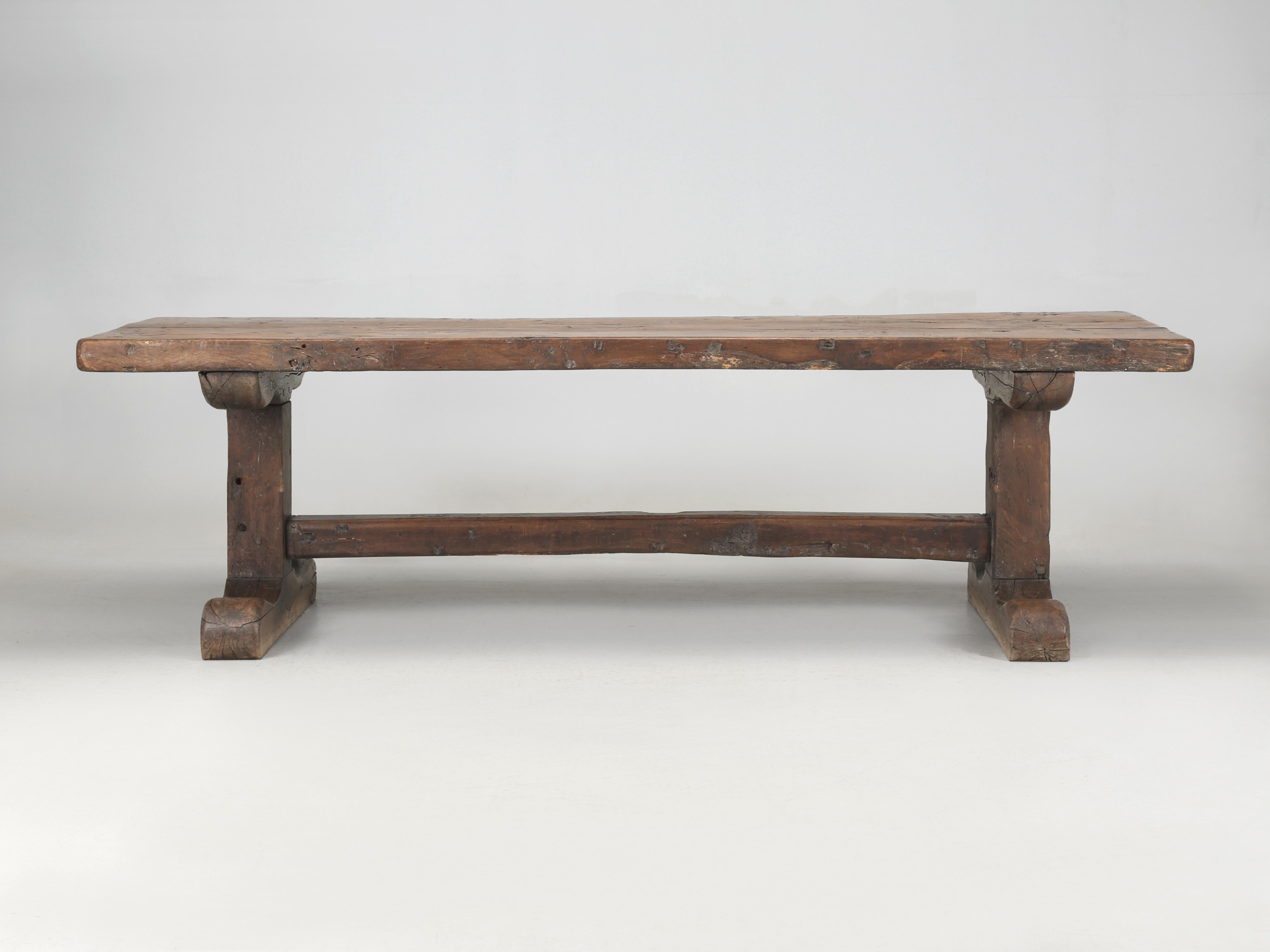 Antique French Oak Trestle Dining Table that appears to be over 200-years old. We purposely left the patina completely original, even down to the very bottom of the trestles where you can see how mopping the floor lightened the oak. The temptation