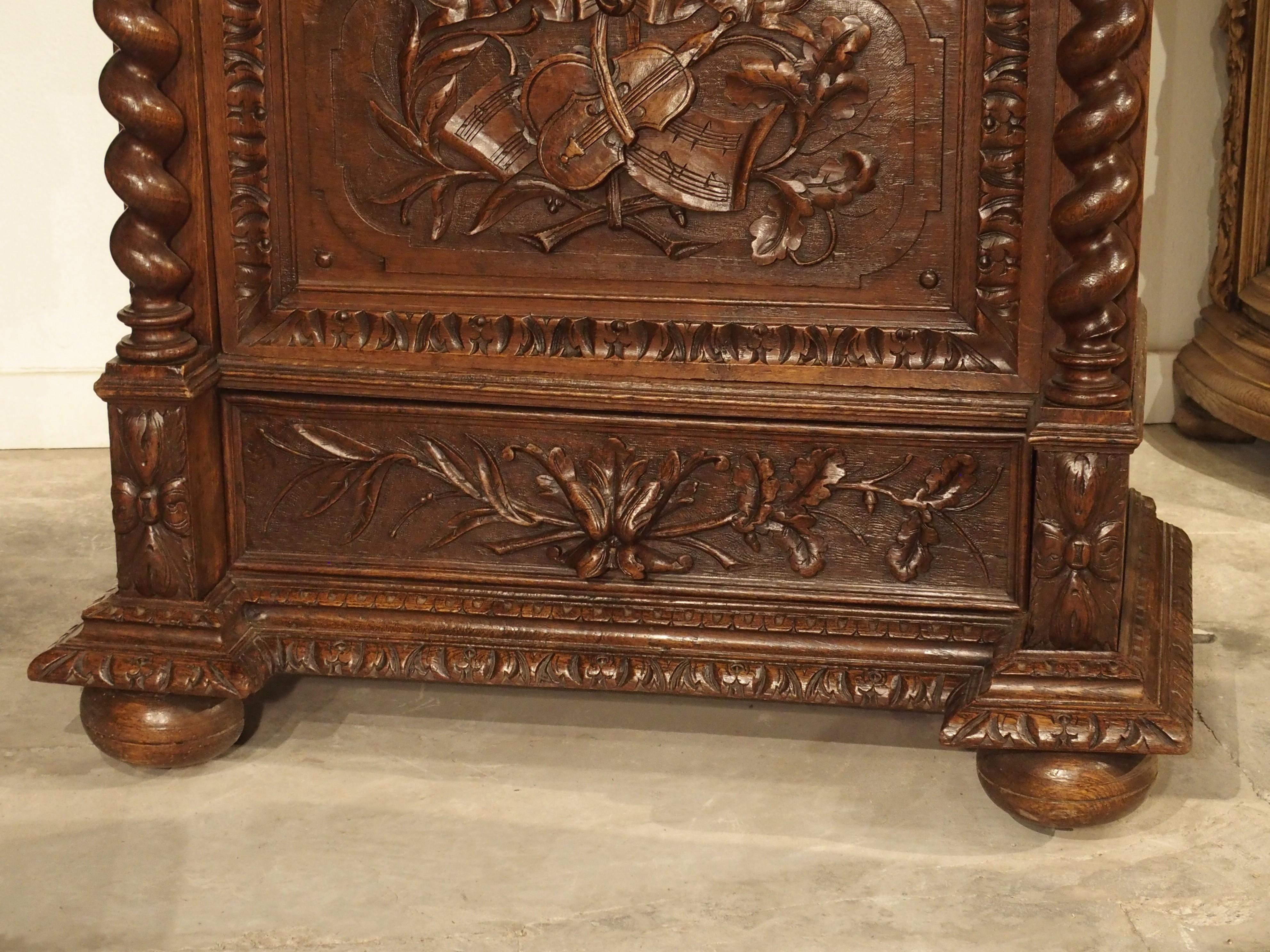 Hand-Carved Antique French Oak Vitrine with Musical Carvings and Turned Columns, circa 1890