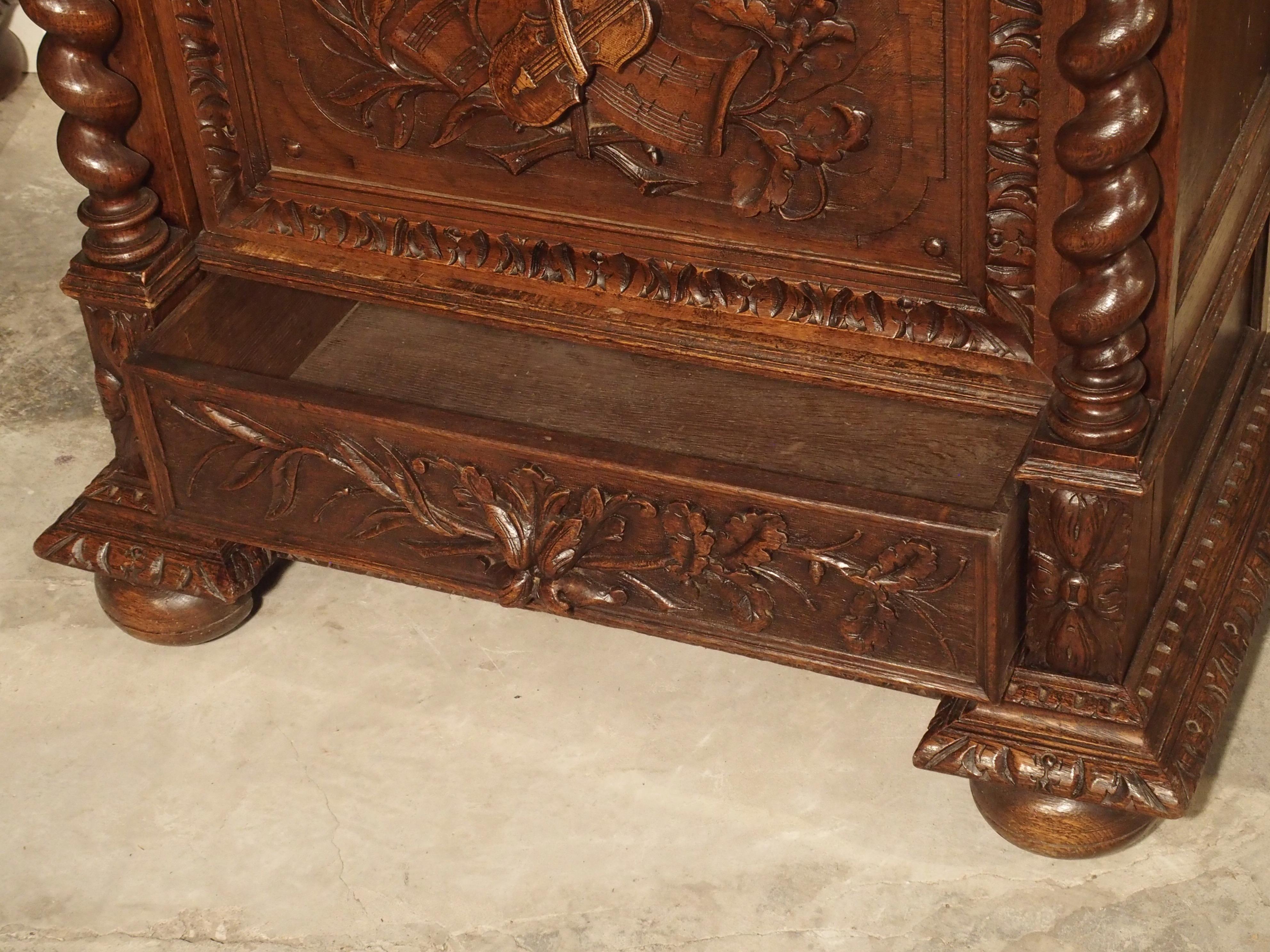 Glass Antique French Oak Vitrine with Musical Carvings and Turned Columns, circa 1890