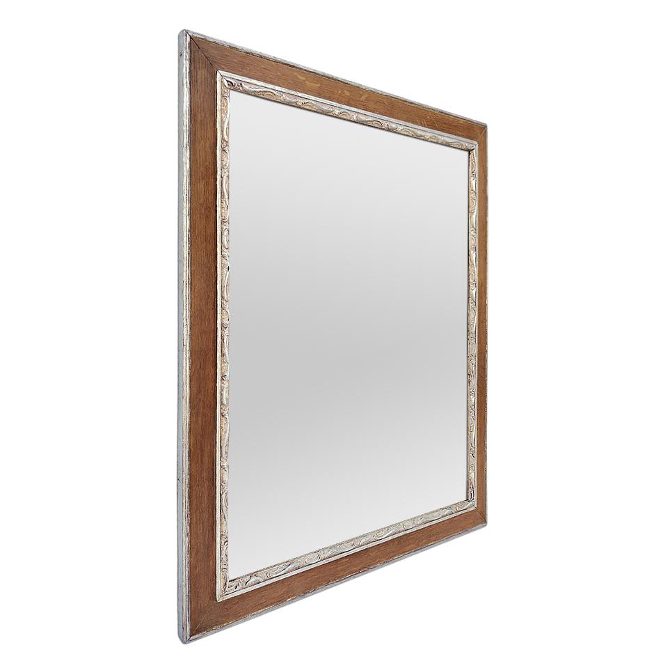 Antique oak wood mirror with silvered wood stylized decors, circa 1940. Re-gilding to the leaf patinated. Antique frame width: 1.96 in / 5 cm. Modern glass mirror. Antique wood back.