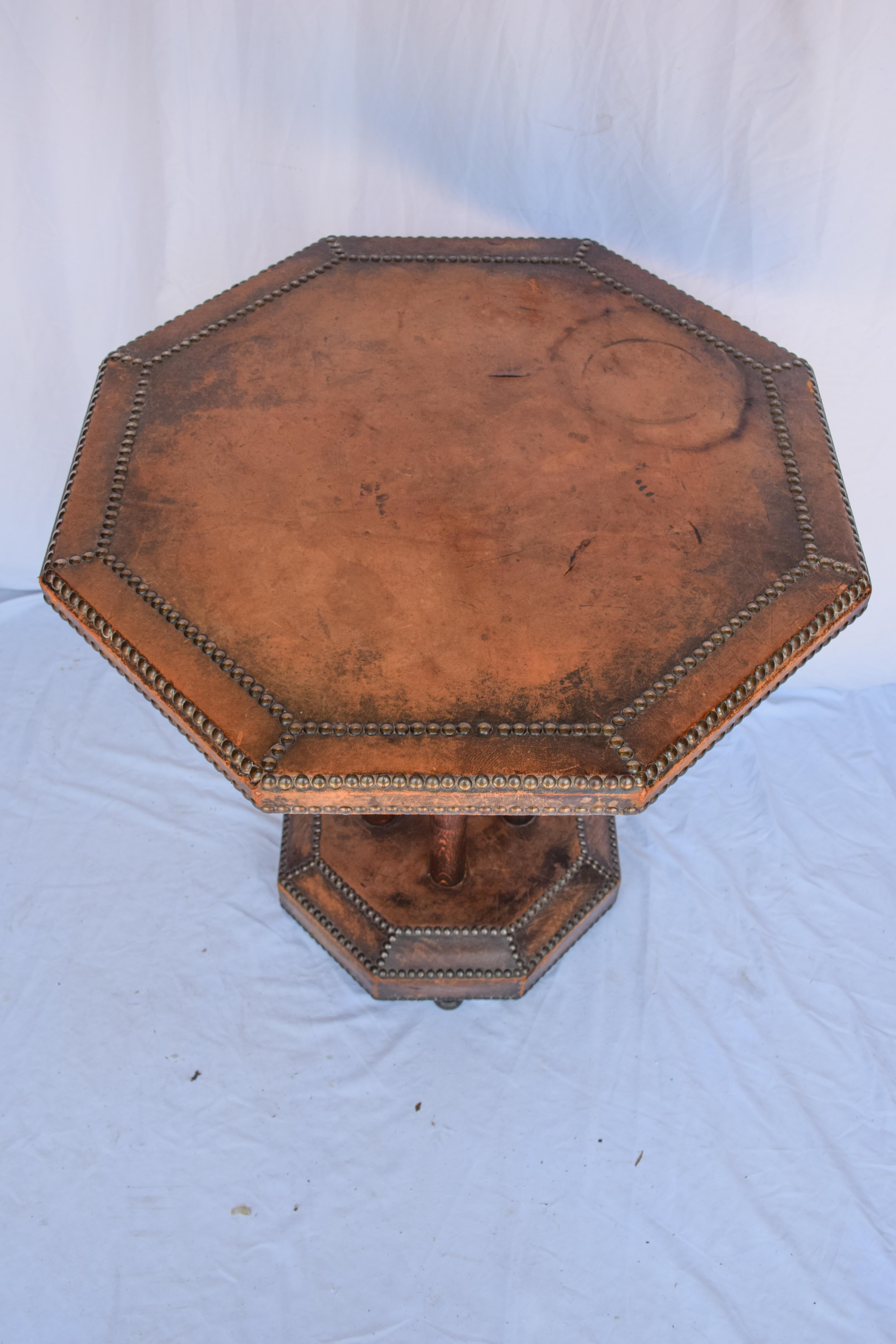 French Art Deco distressed leather side bistro table.
Unique shape antique octagonal wood table with leather wrapped top with studded detail also covered in a studded leather.
Great antique patina, the leather is well used but still in good