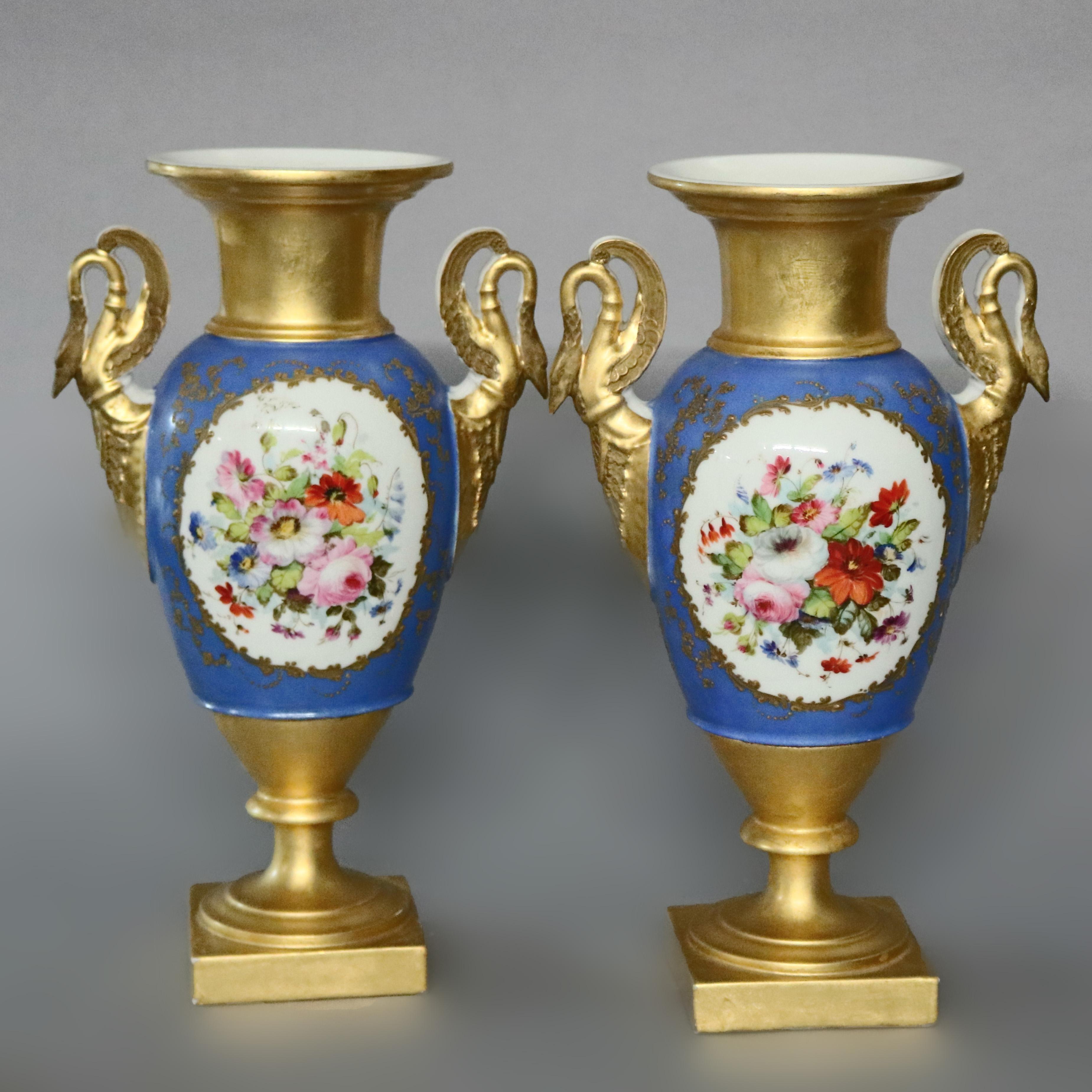 An antique pair of large French Old Paris porcelain vases offer urn form, each with hand painted reserves including courting scenes and en verso floral flanked by gilt figural swan handles, heavily gilt neck and base, circa 1910


Measures: