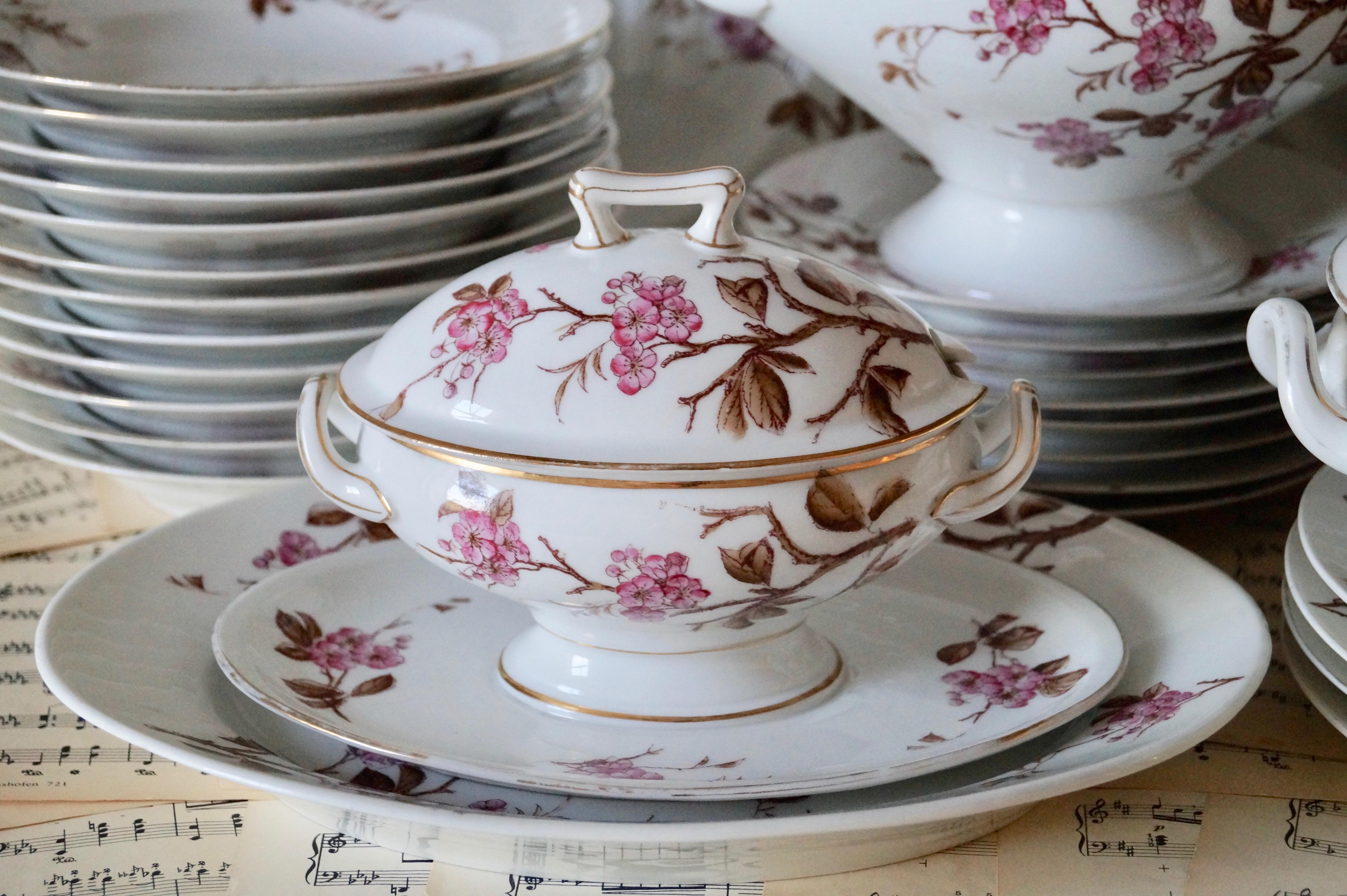 Gorgeous antique French porcelain Old Paris dinnerware for 12!.

Beautiful handpainted pattern with pink blossoms and branch. finished with gold decorations.

Good condition, there are gold wear at the edge of the plates and tureens. The lid of