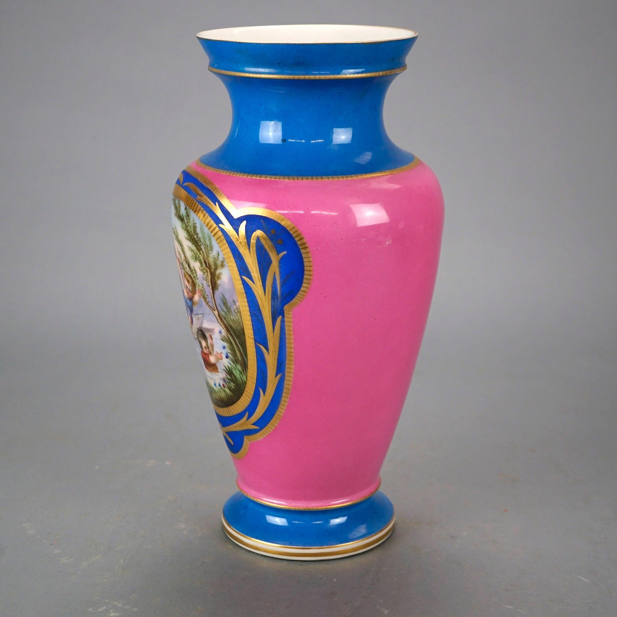 An antique French Old Paris portrait vase offers footed porcelain construction with reserve having hand painted genre scene with children on pink ground, gilt highlights throughout, 19th century

Measures- 13'' H x 6.5'' W x 6.5'' D.