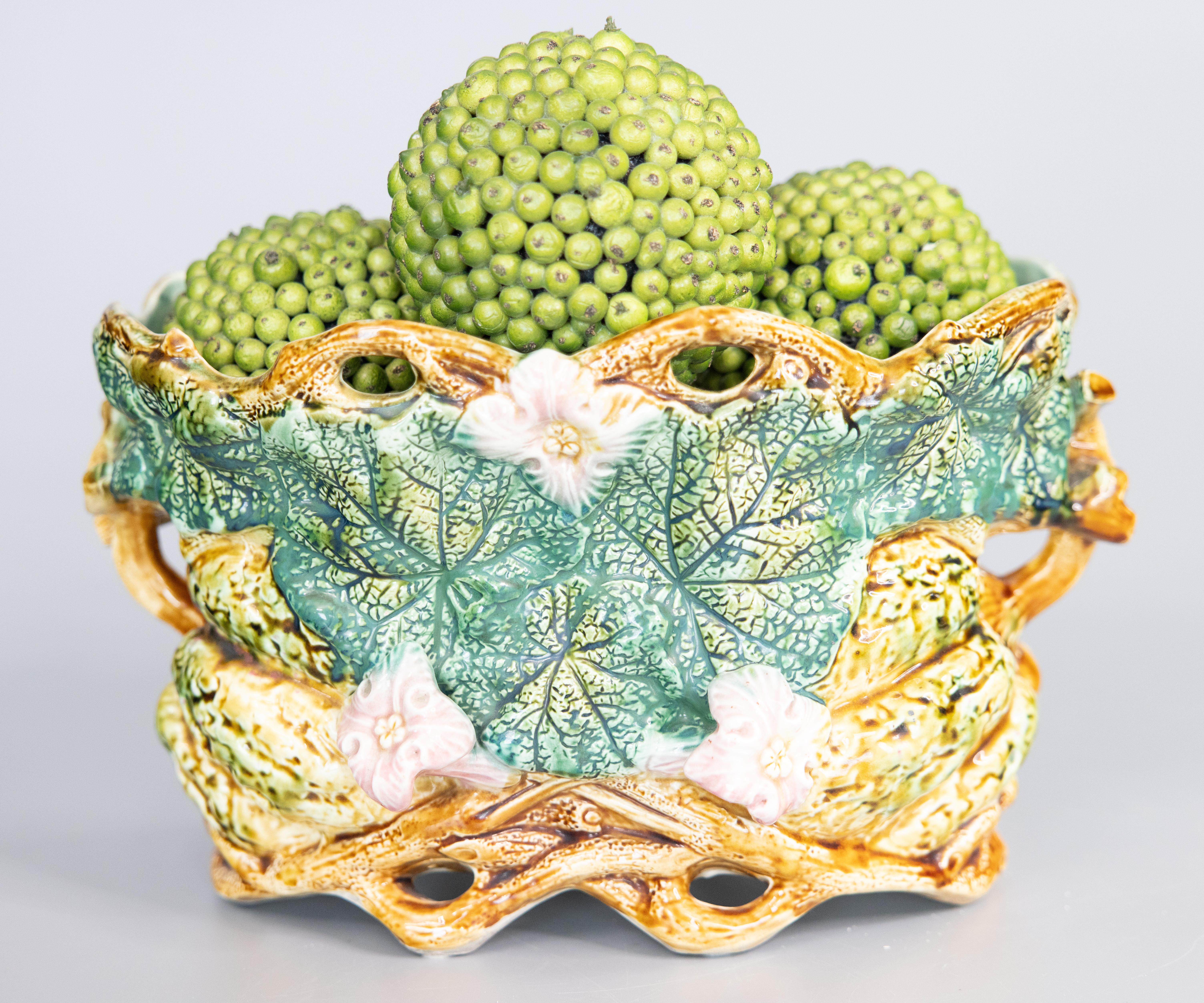 A gorgeous antique French Onnaing majolica pumpkin cachepot / jardiniere / planter, circa 1880. Maker's mark on reverse. This fine jardiniere is a nice large size decorated with vibrant green pumpkin leaves, lovely blush pink flowers, and twined