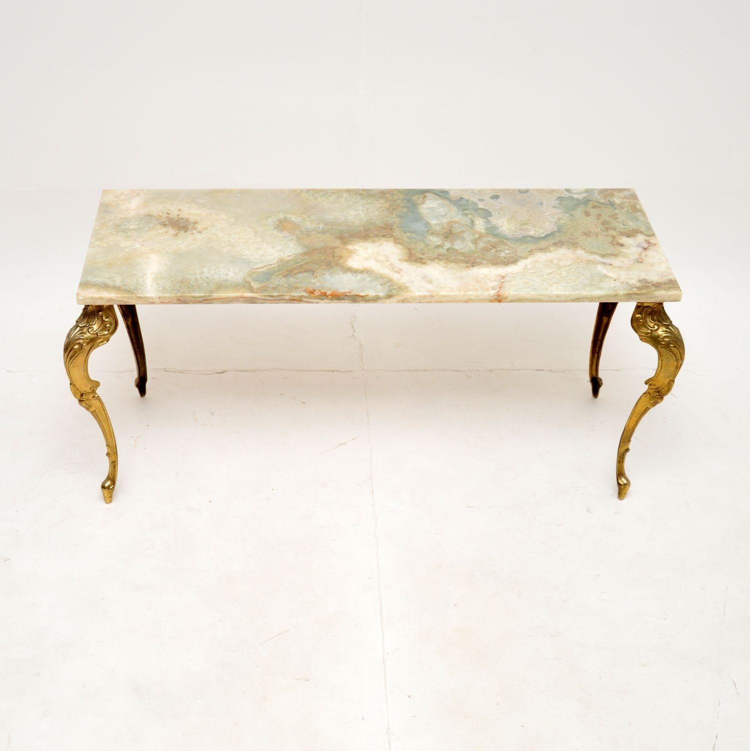 A beautiful and elegant antique French onyx and brass coffee table, dating from the 1930’s.

It is of excellent quality and is a very useful size. The onyx top is absolutely stunning, with incredible colours and grain patterns. It sits loose on the