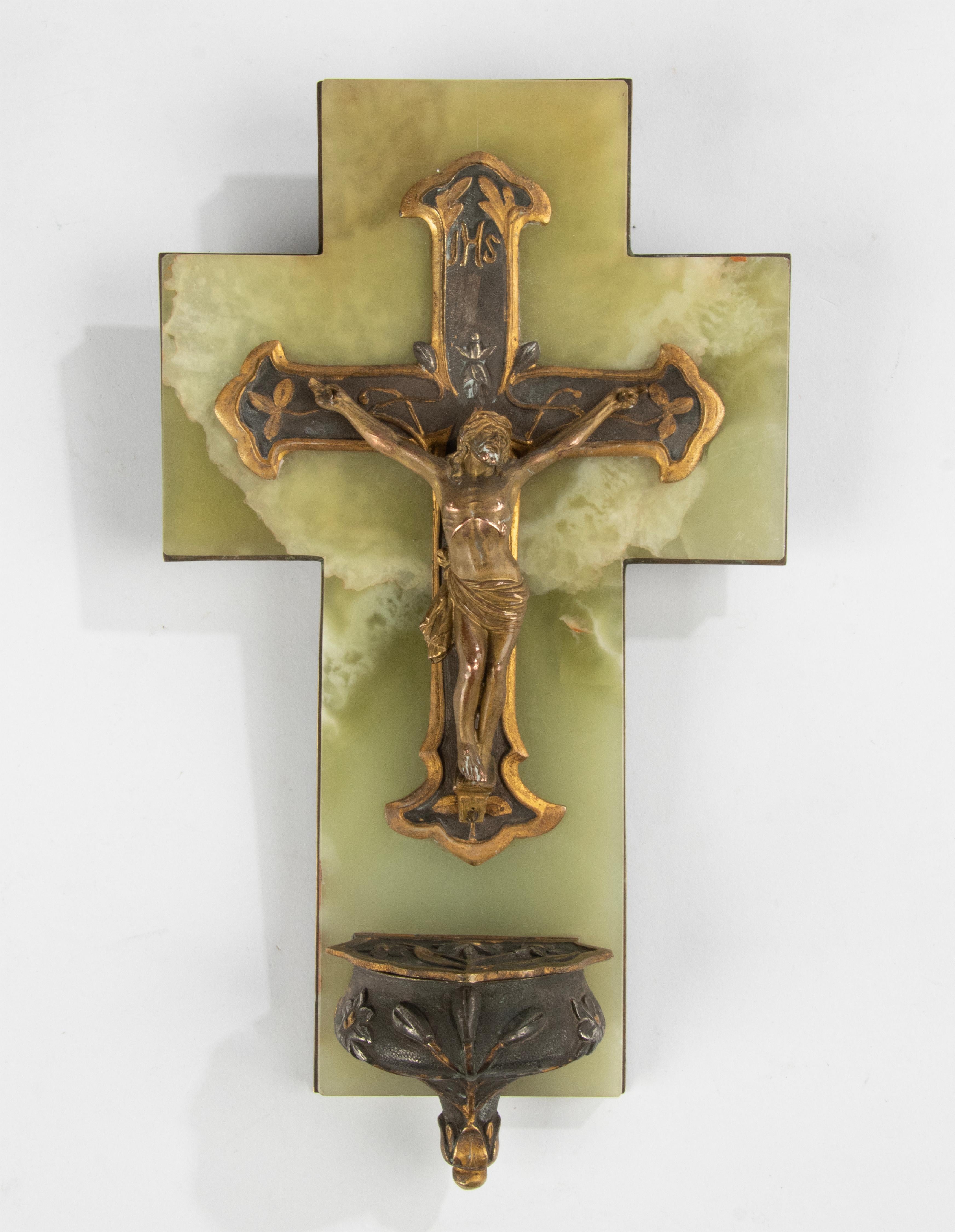 Early 20th century holy water font with Jesus Christ on his cross and a small holy water lidded bowl at the bottom. The back is covered with a brass plate, engraved and dated on the backside: 1911. The object is in very good condition
Dimensions: