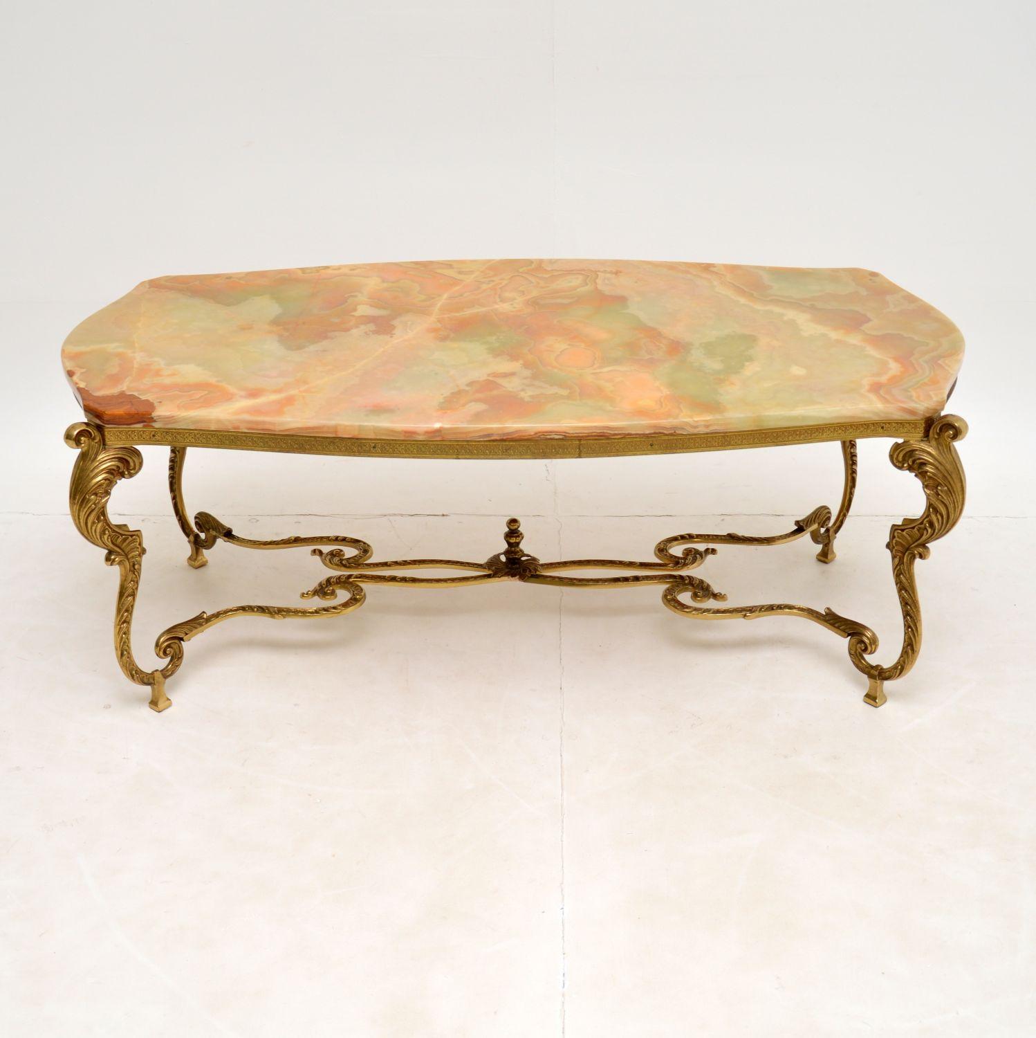 A stunning antique coffee table with a gorgeous brass frame and shaped onyx top. This was made in France, it dates from around the 1920-30’s.

The quality is amazing, this has a fantastically detailed solid brass frame which has such a beautiful