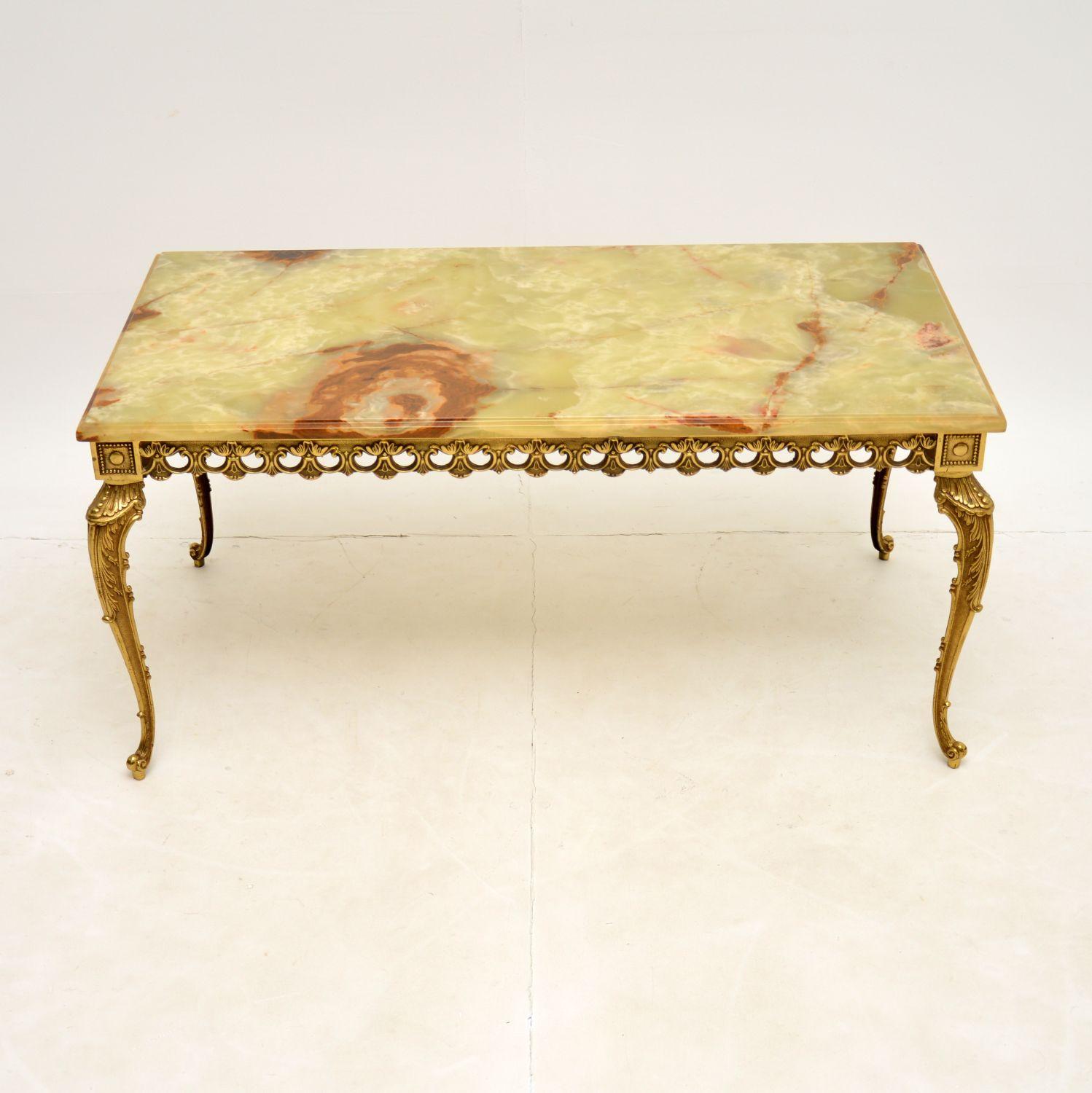 A stunning antique brass & onyx top coffee table. This was made in France, it dates from around the 1920-30’s.

The quality is excellent, this has a beautifully detailed solid brass frame. The onyx top has stunning colours and patterns, and is