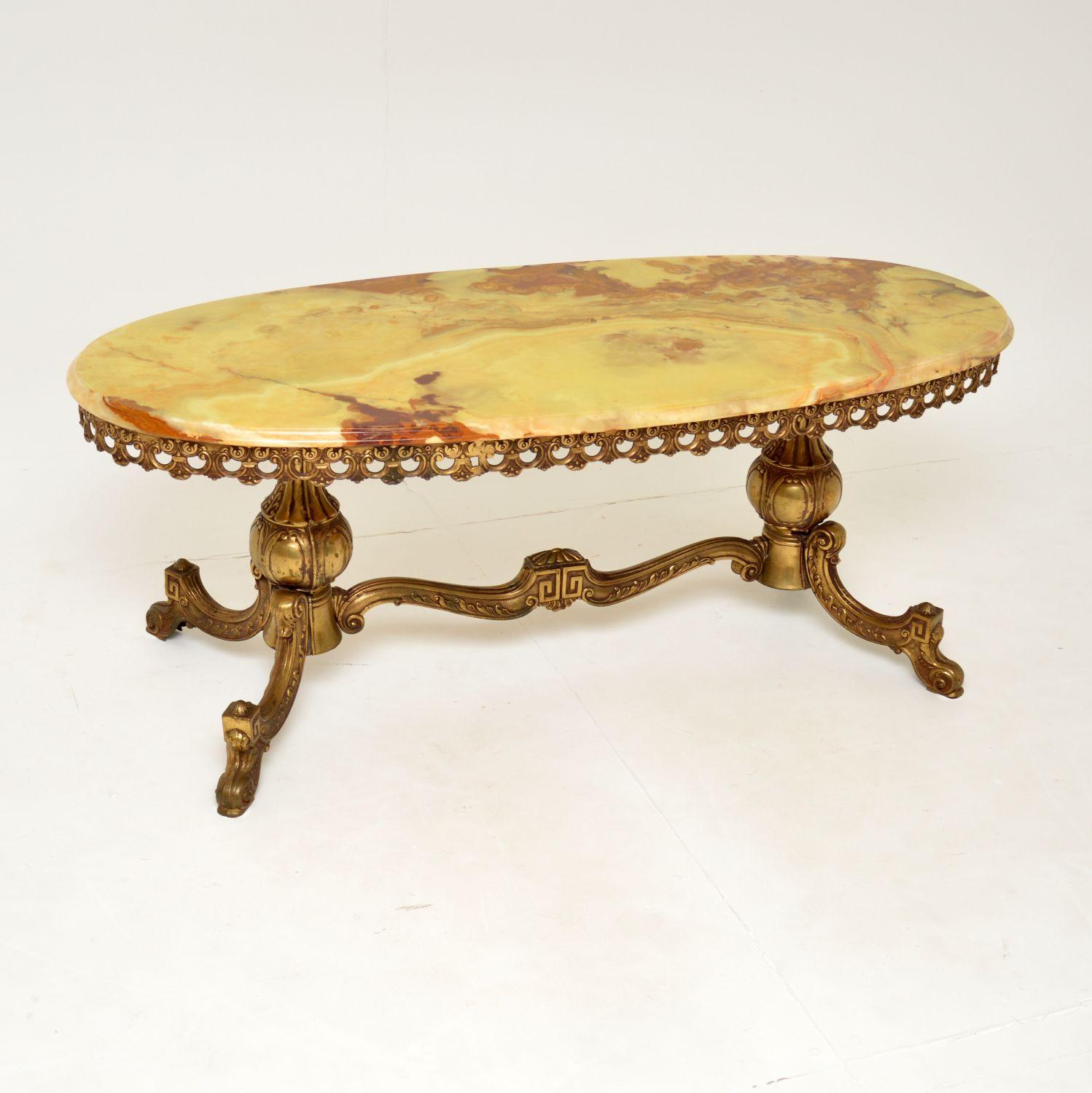 A beautiful antique coffee table with an ornate brass frame and gorgeous onyx top. This was made in France, it dates from around the 1950’s.

It’s of fabulous quality, with intricate details in the base, the onyx top has stunning colours and