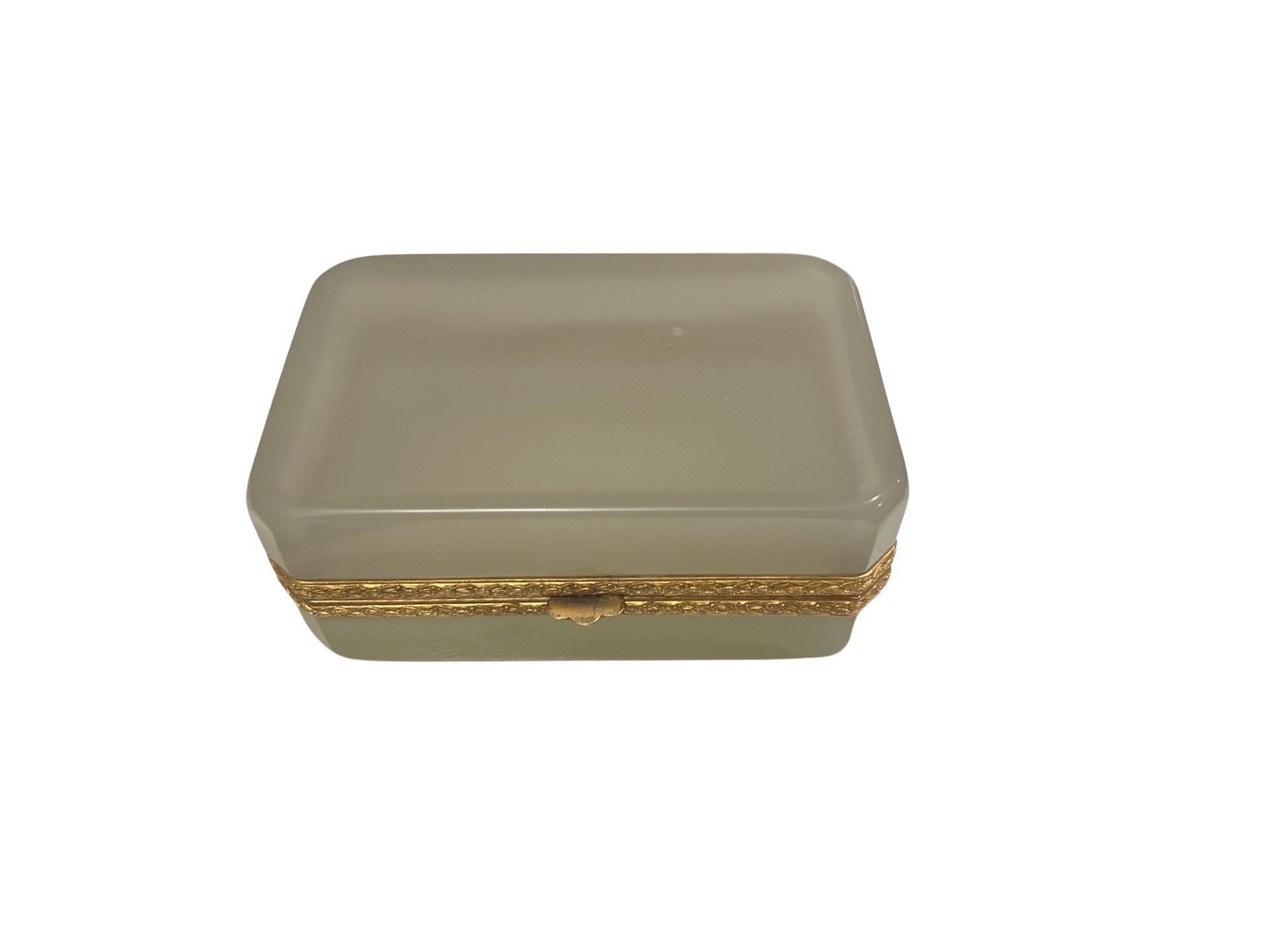 French, early 20th century.
An antique French opaline glass casket having a doré bronze hinge and banding.