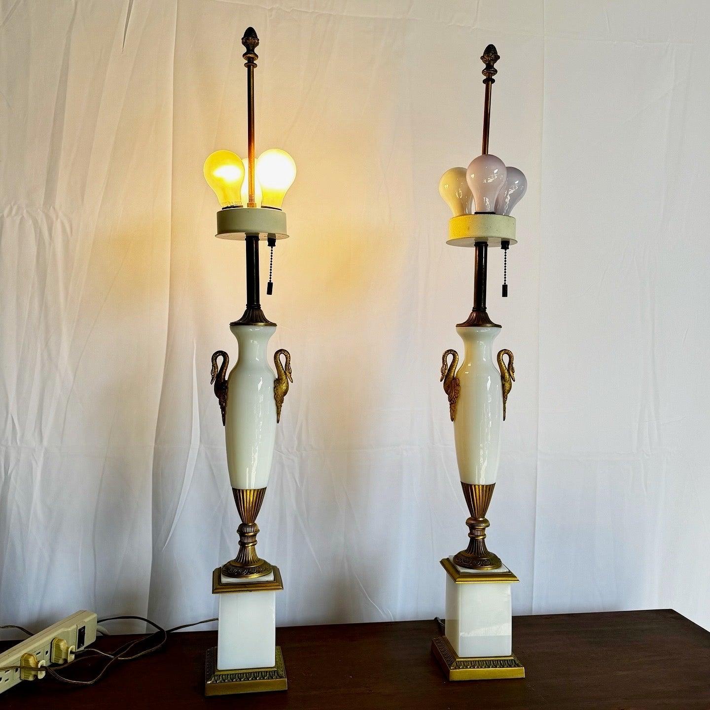 Exquisite pair of Antique French Opaline Glass Lamps with swan-shaped handles and gold accents, adding elegance to any decor.
 
 One of the labels has faulty wiring and needs to be rewired. In that same lamp the metal at the bottom section is loose