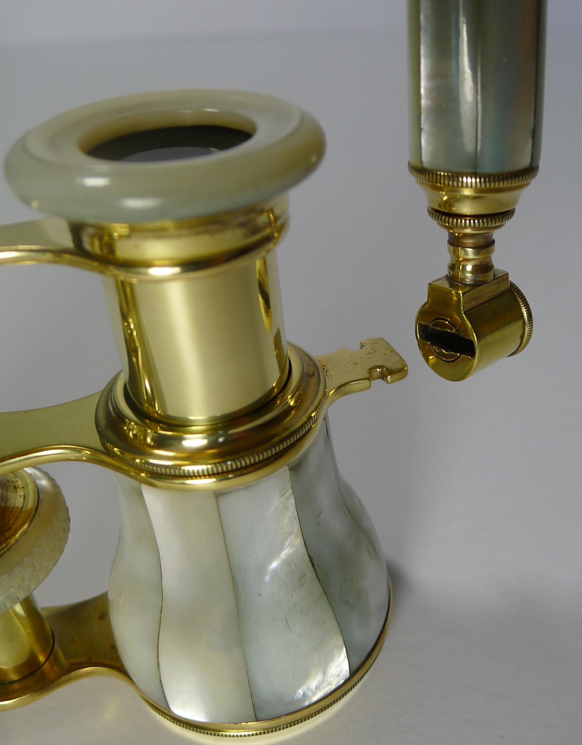 A wonderful and most unusual pair of antique French opera glasses dating to circa 1900 made from polished brass and bright mother of pearl shell.

The telescopic handle is what makes these a rare and unusual find, the handle when pushed in can be
