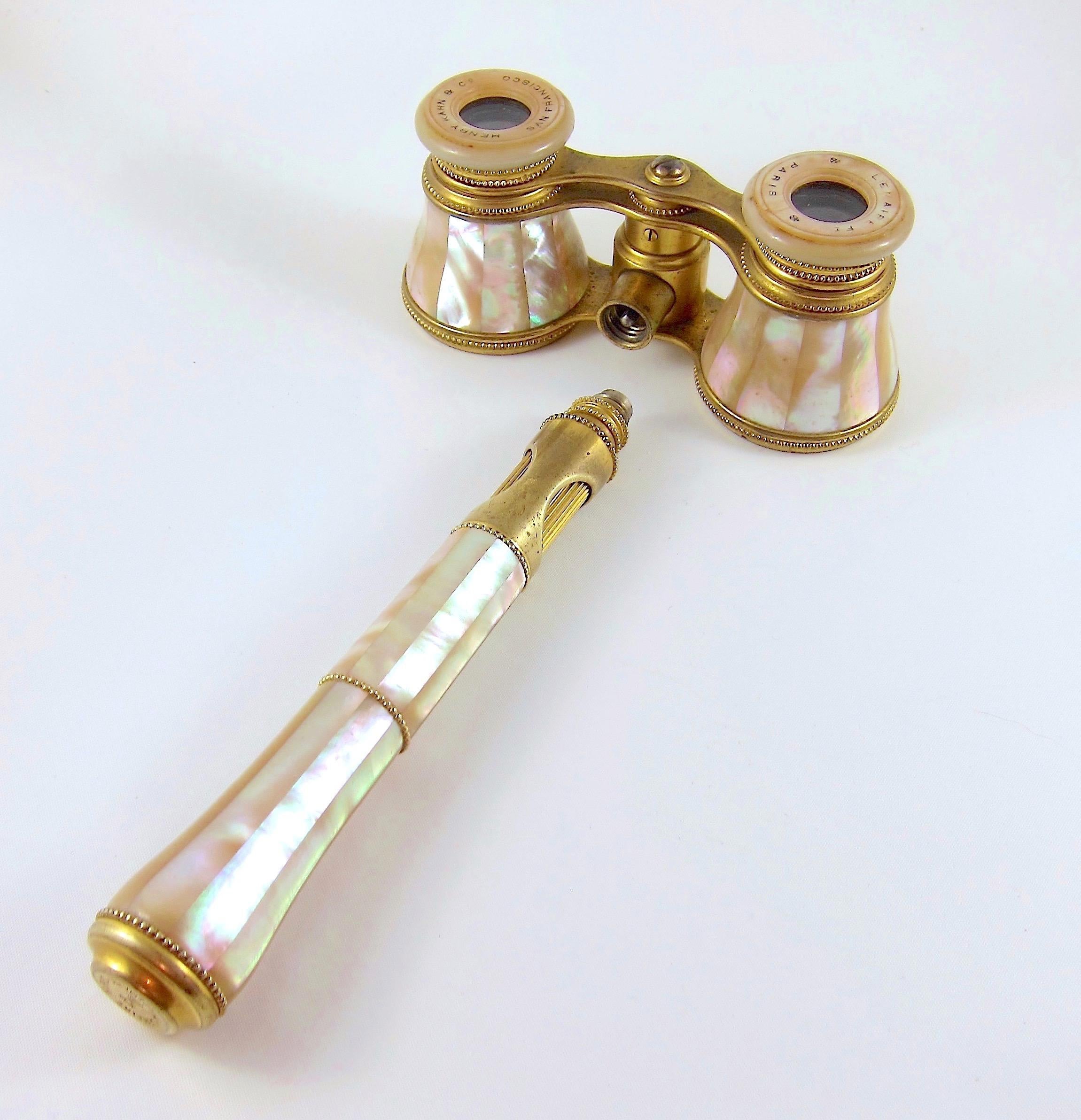 An elegant pair of antique French opera glasses with an unusual detachable handle. The small binoculars date to the late 19th century and were crafted at the height of the Belle Époque in gilt metal and mother of pearl by Lemaire of Paris. 

The