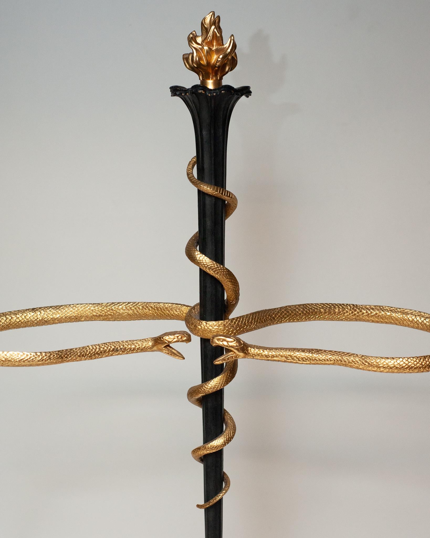 A stunning and unusual French antique umbrella stand in metal with ormolu details, featuring two snakes wrapped around the centre column and flame finial. Beautifully made and in good condition for it’s age and use, this is the perfect accent piece