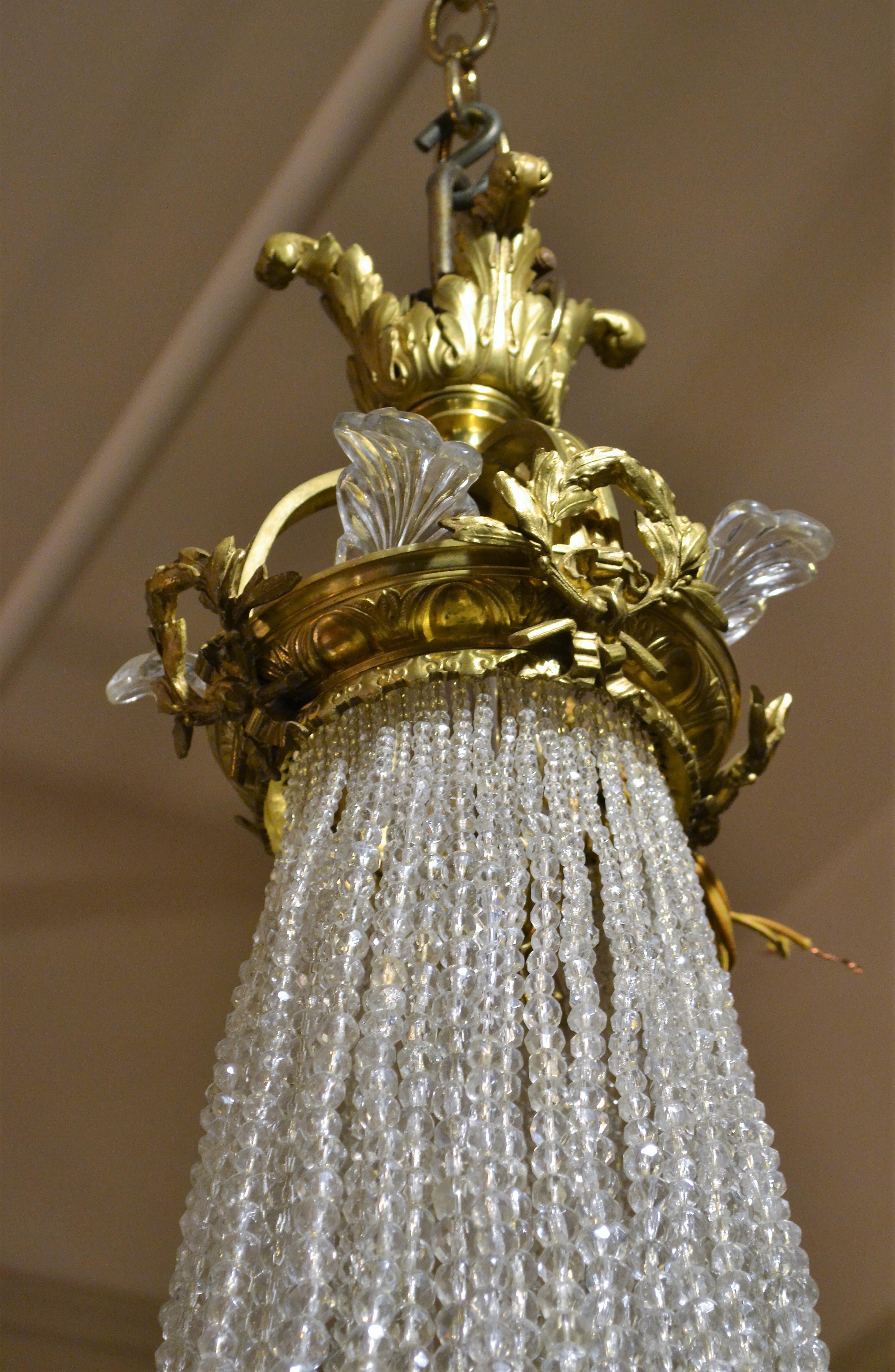 Antique French ormolu and richly beaded chandelier.