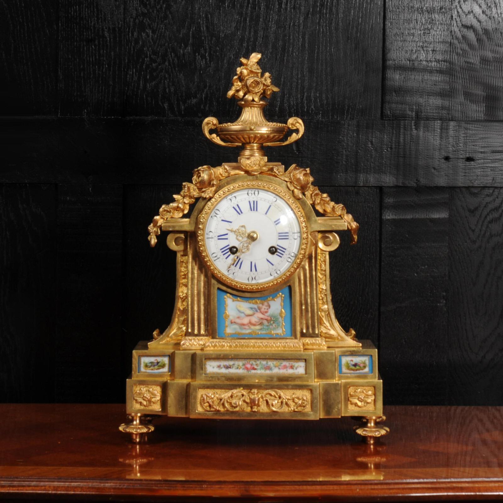 A lovely early antique French ormolu clock by Louis Japy, part of the great Japy clockmaking dynasty. It is of Louis XVI design and mounted with exquisite Sèvres style porcelain panels. The porcelain has a Bleu Celeste ground with delicately cherub,