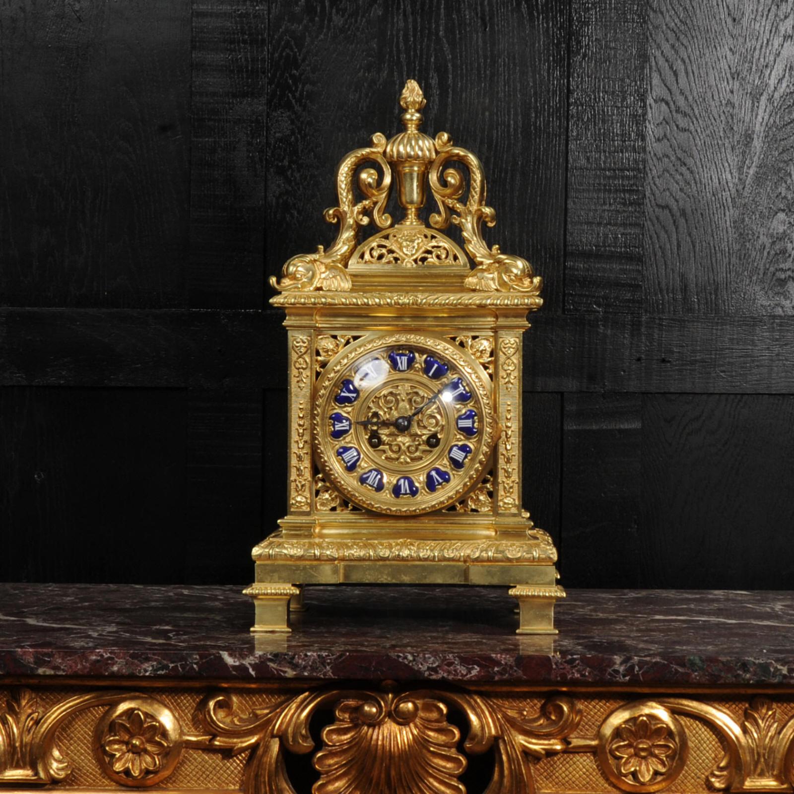 A superb Baroque style antique French bracket clock. Finely and heavily made in Ormolu (finely gilded bronze), it is formed of fretted panels with profuse decoration. To the top of four beautifully modelled dolphins surrounding a flaming urn. The
