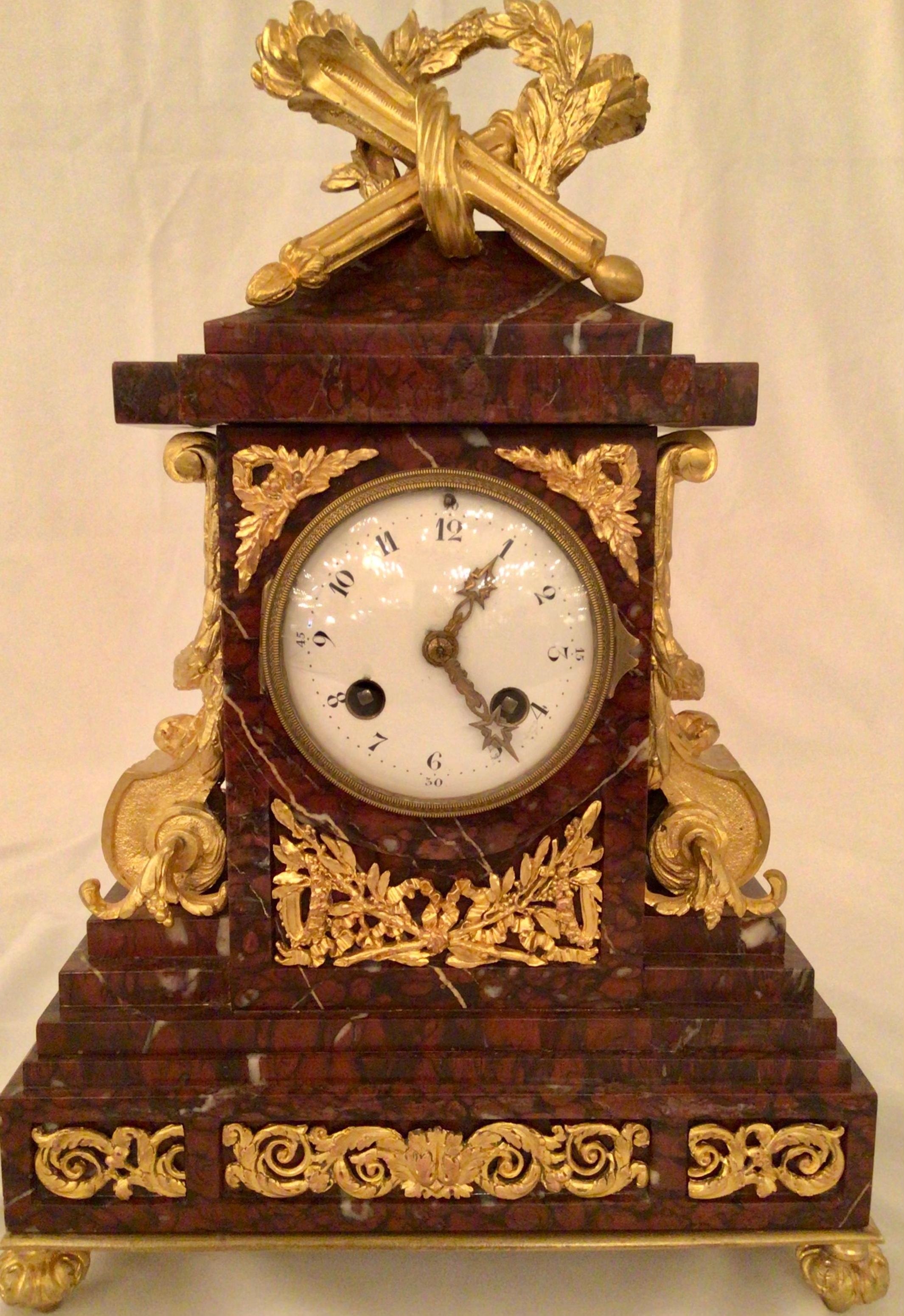 Antique French exquisite quality Ormolu clock and candlesticks of Vatican rouge marble, circa 1875-1885

Clock measures 15” H x 10” W x 4 1/2” D
Candlestick measures 13” H x 7” W x 5” D

CLF084.