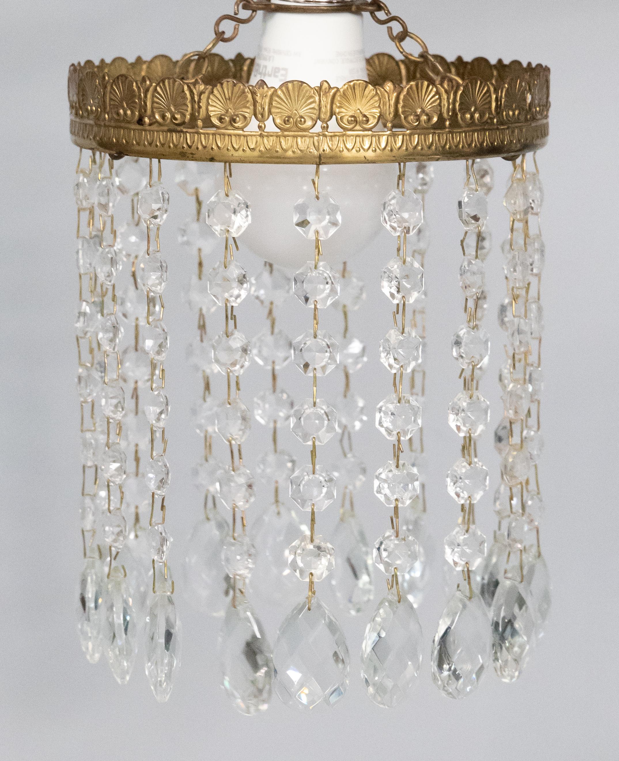 A gorgeous petite 1920s French electrolier chandelier light shade with glass droplets suspended from a gilded ormolu brass crown frame. This lovely chandelier can be fitted around an ordinary ceiling pendant light bulb, casting a pleasant light,