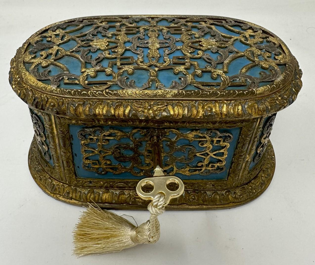 An extremely stylish French Gilt Bronze Ladies Jewellery heavy gauge dome topped Casket of outstanding quality. Third quarter of the Nineteenth Century.  

The main outer body superbly decorated in filigree style scrolling panel decoration on a blue