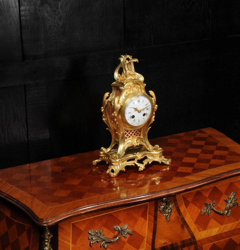 A stunning antique French ormolu Rococo clock, circa 1880. It is beautifully modelled in the Rococo style of Louis XV in Ormolu (gilded bronze). Beautiful balloon shaped case with acanthus to the shoulders and a Rococo flourish to the top. Sound