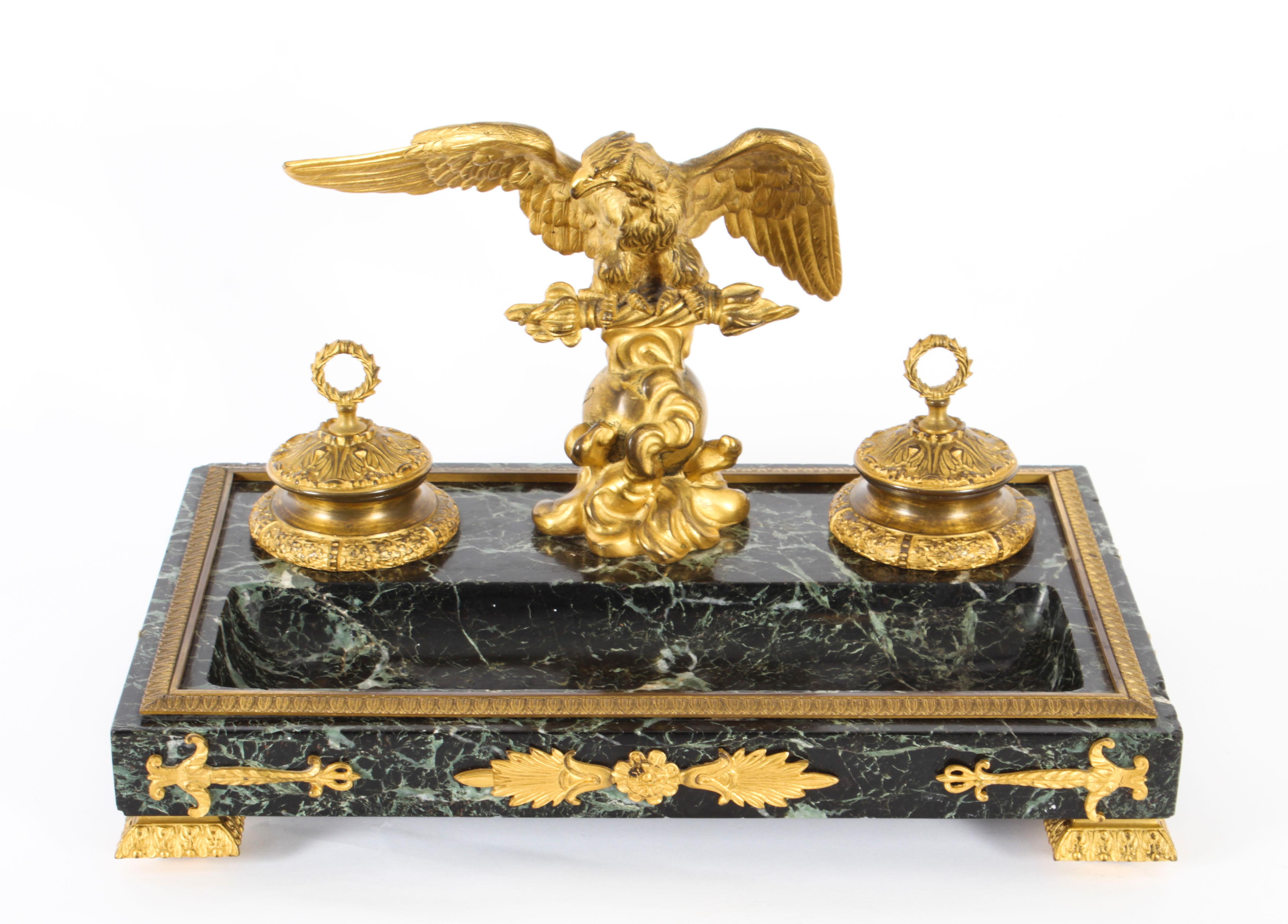 This is a wonderful antique French Empire Revival ormolu mounted and patinated Verde Antico marble inkstand, Circa 1870 in date.
 
Of rectangular form with a pair of raised inkwells with glass liners having ormolu covers, surmounted by a spread