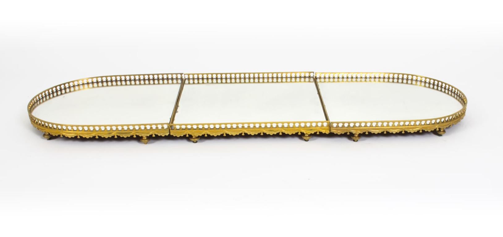 This is a superb antique French ormolu surtout-de-table or mirrored plateau in the classic Louis XVI style, circa 1870 in date.
 
The elongated oval form features three mirrored sections with their original inset mirrored glass. The mirror is
