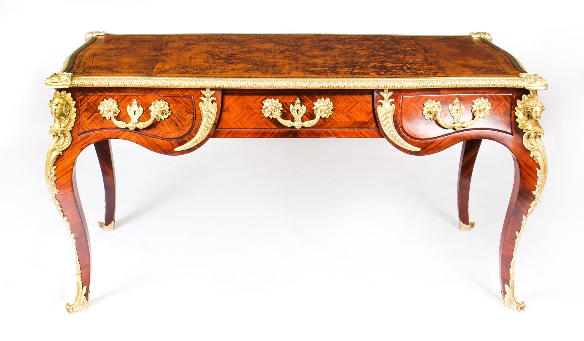 This is a beautiful and rare antique ormolu mounted French  bureau plat, circa 1860 in date.

It has highly decorative ormolu mounts and the shaped rectangular top has a decorative ormolu border and is inset with a superb gilt-tooled tan leather