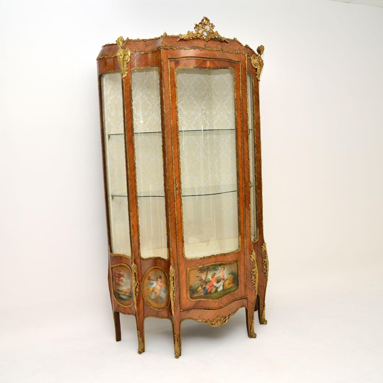 A stunning and extremely impressive antique French Louis XIV style display cabinet, which I would date from around the 1930-50’s period. It is both breakfront & serpentine shaped.
It is of amazing quality, you don’t often see them in this scale and