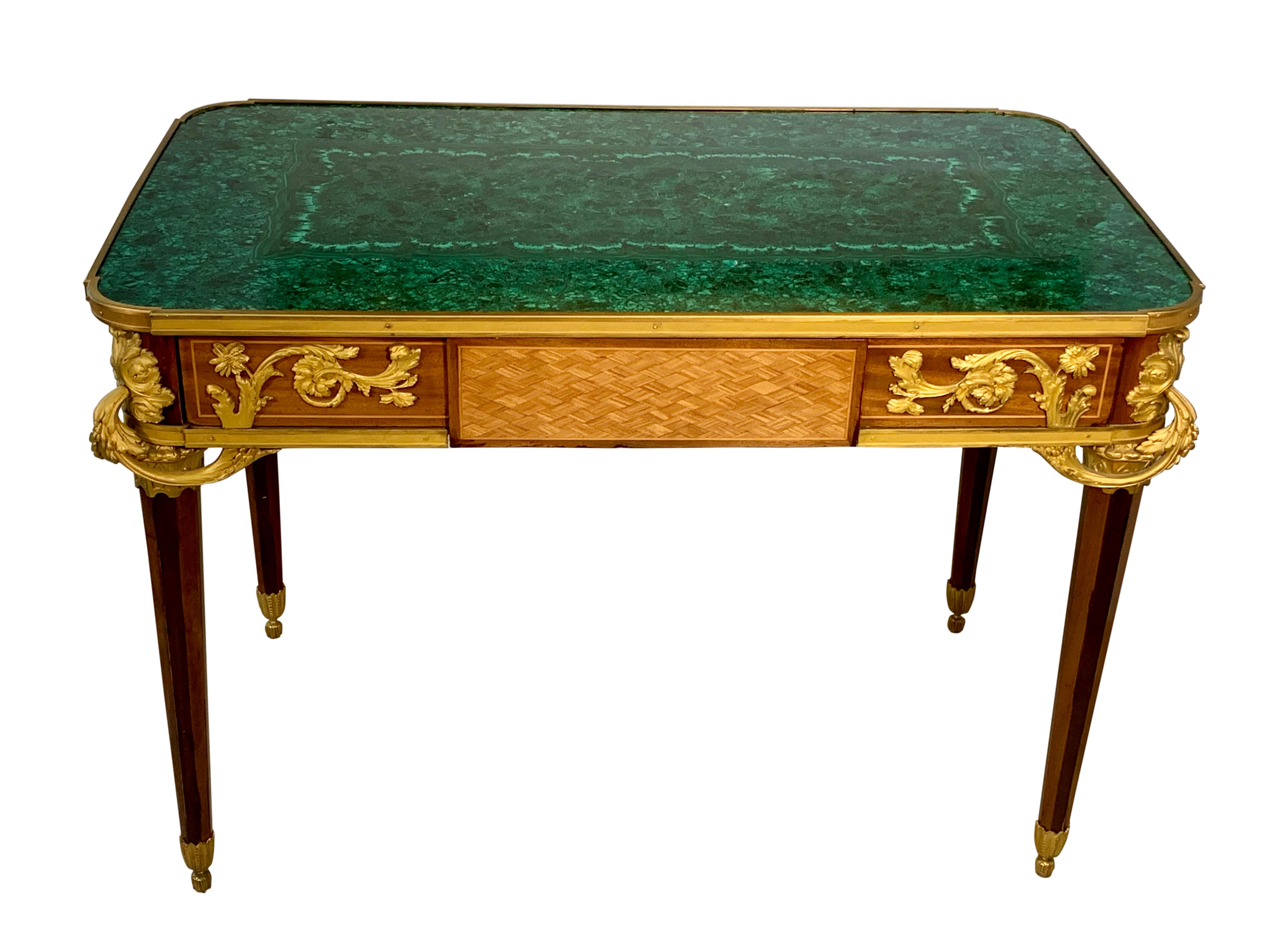 A fine Louis XVI style gilt-bronze mounted mahogany kingwood and malachite table De Salon in the manner of Jean-Henri riesener. With malachite inset rounded corner top, above a frieze drawer, the angles with outscrolled acanthus chutes on tapering