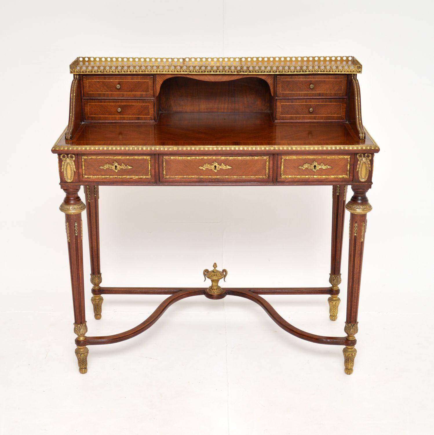 An absolutely stunning antique French secretaire desk, dating from around the 1930’s period.

There are amazing gilt bronze features throughout, with a pierced upper gallery, mounts on all edges, drawers and on the base too. The legs are fluted &