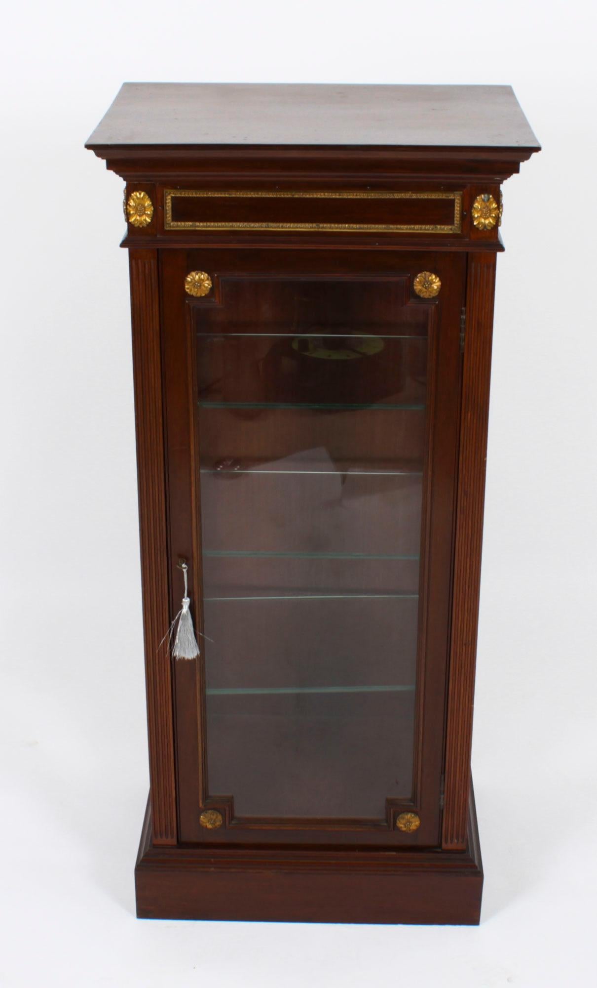 This is a beautiful antique French ormolu mounted mahogany vitrine, circa 1870 in date.
 
This beautiful cabinet is of slender form with gilt bronze ormolu mounts and a moulded cornice. The cornice sits above a glazed panelled door and glazed
