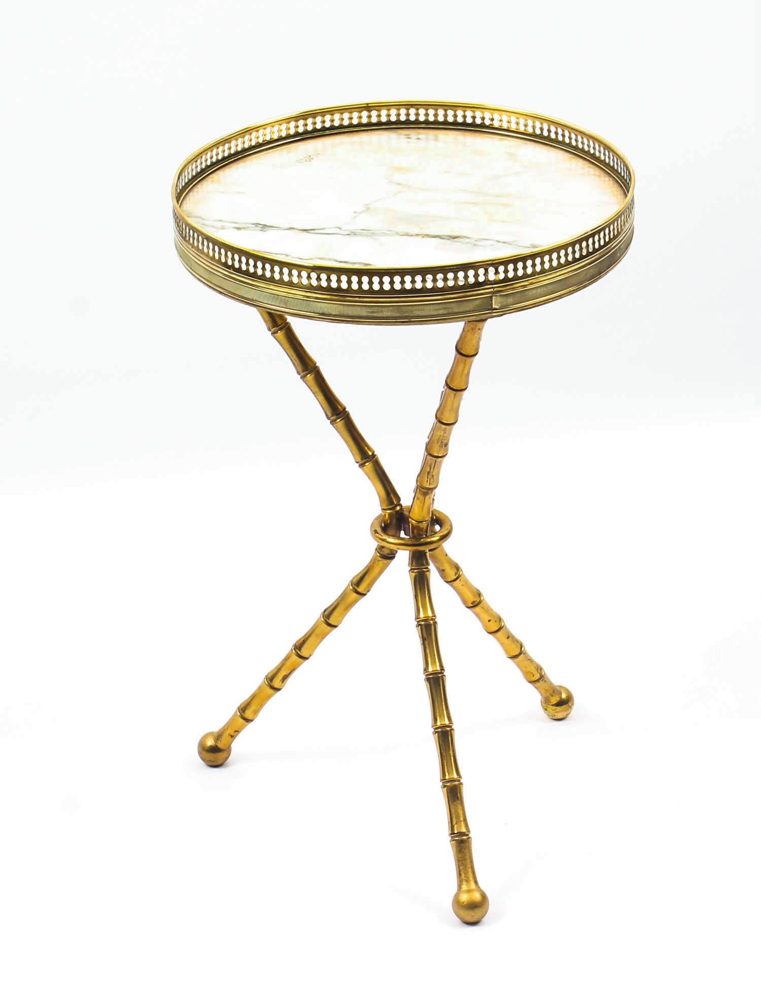 This is a beautiful antique French ormolu occasional table, with an inset circular white variegated Carrara marble-top, circa 1880 in date.

It has been masterfully crafted from ormolu, the marble top with a pierced brass gallery supported by a