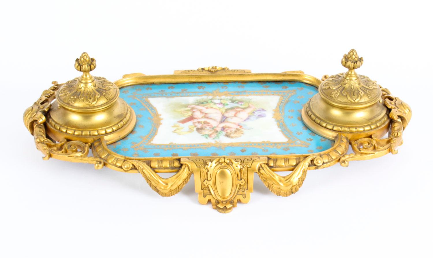 This is a wonderful antique French ormolu inkstand, mounted with Bleu Celeste Sèvres porcelain circa 1870 in date.

Of rectangular form with a pair of raised inkwells with porcelain liners having ormolu covers, and centered with a large hand