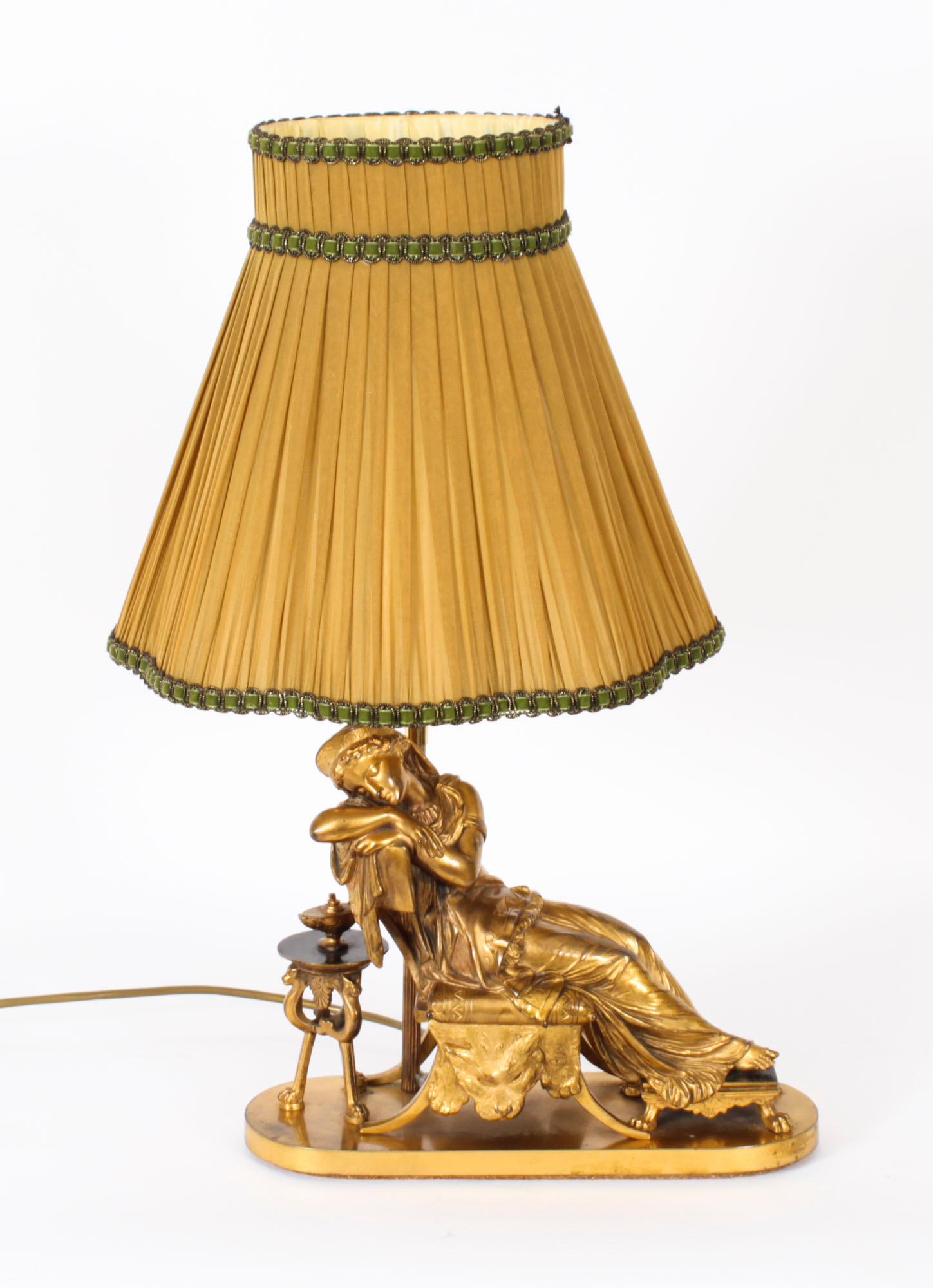 This is a fine antique ormolu Louis XVI Revival table lamp in the manner of Pierre-Jules Cavelier (French 1814-1894), circa 1890 in date.

The ormolu sculpture is modelled as a classical maiden figure sleeping on a klimos chair, a table set with a