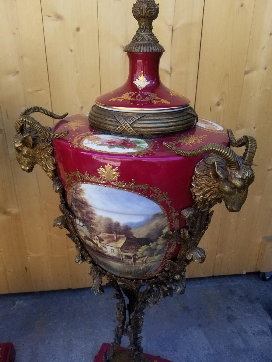 Antique French Ornate Rams' Head Ormolu Mounted Hand Painted Porcelain Sèvres Lidded Urn Vases - Pair

These French vases each contain three beautiful hand painted pastoral scenes. Their ormolu stands and handles have been cast with rams' heads