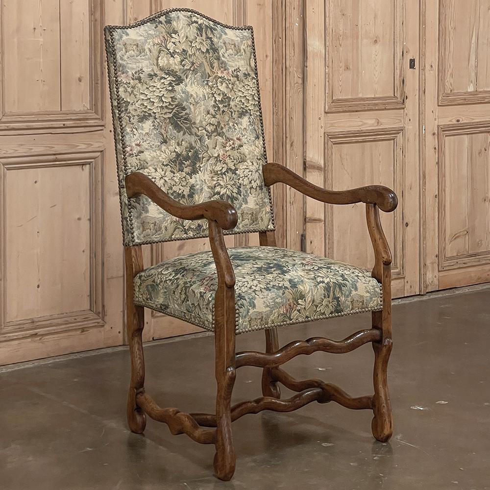 Antique French Os de Mouton armchair with Tapestry is a classic design rendered from solid oak and upholstered in beautiful, earth-toned long-wearing tapestry fabric! The generous arched seatback is great for all heights, especially combined with