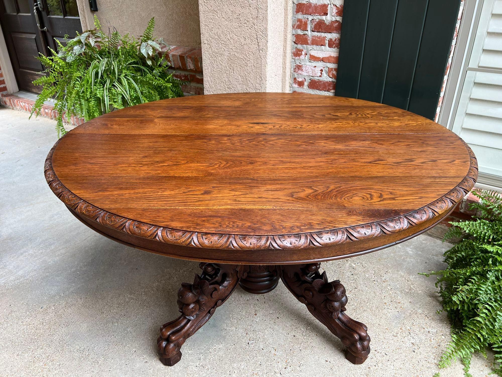 Antique French Oval Dining Table Carved Oak Black Forest Sofa Library Griffin.

Direct from France, a large and substantial 19th century hand carved oval table!
Superior carvings, craftsmanship and artistry; the huge turned baluster has carved
