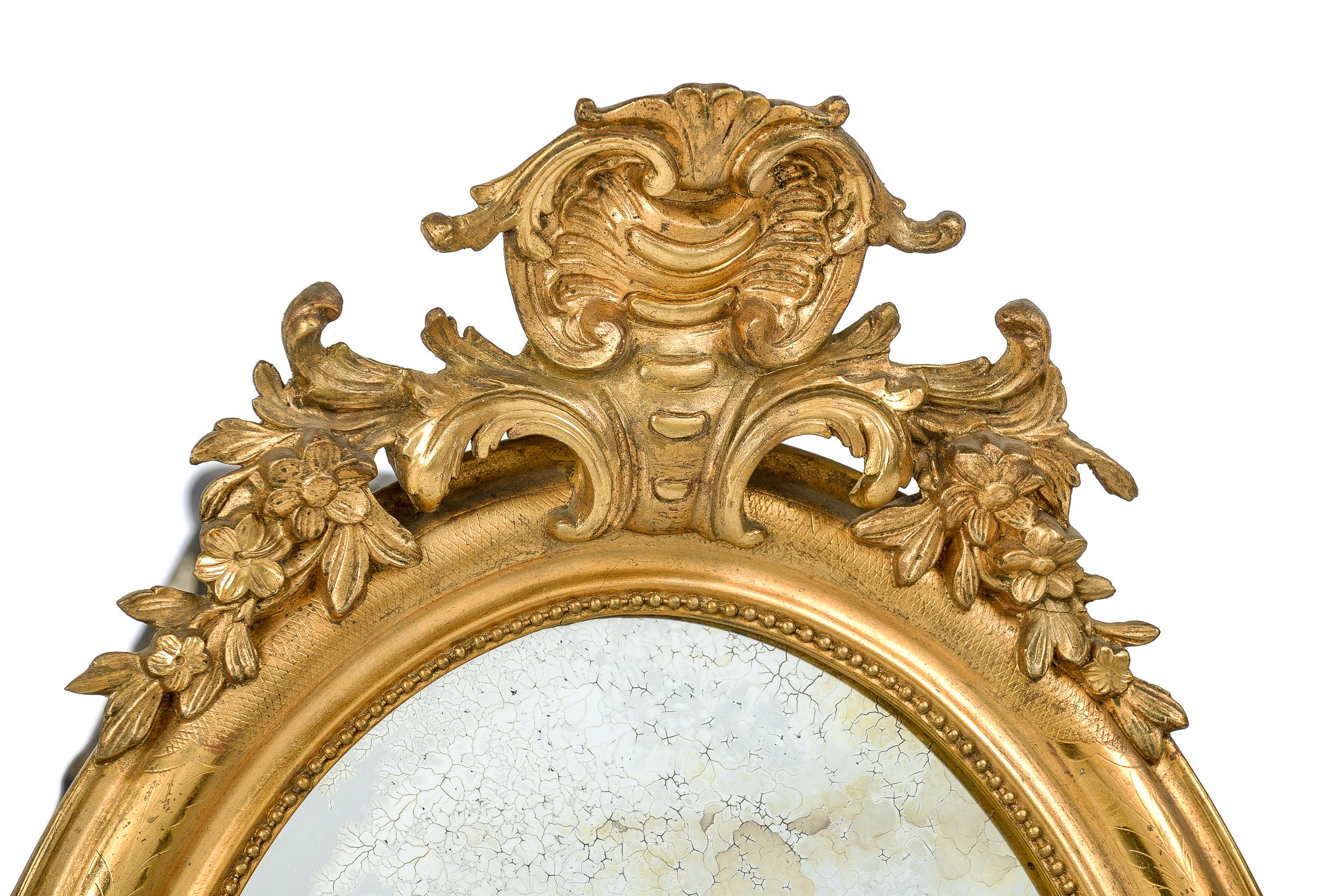 gold ornate oval mirror
