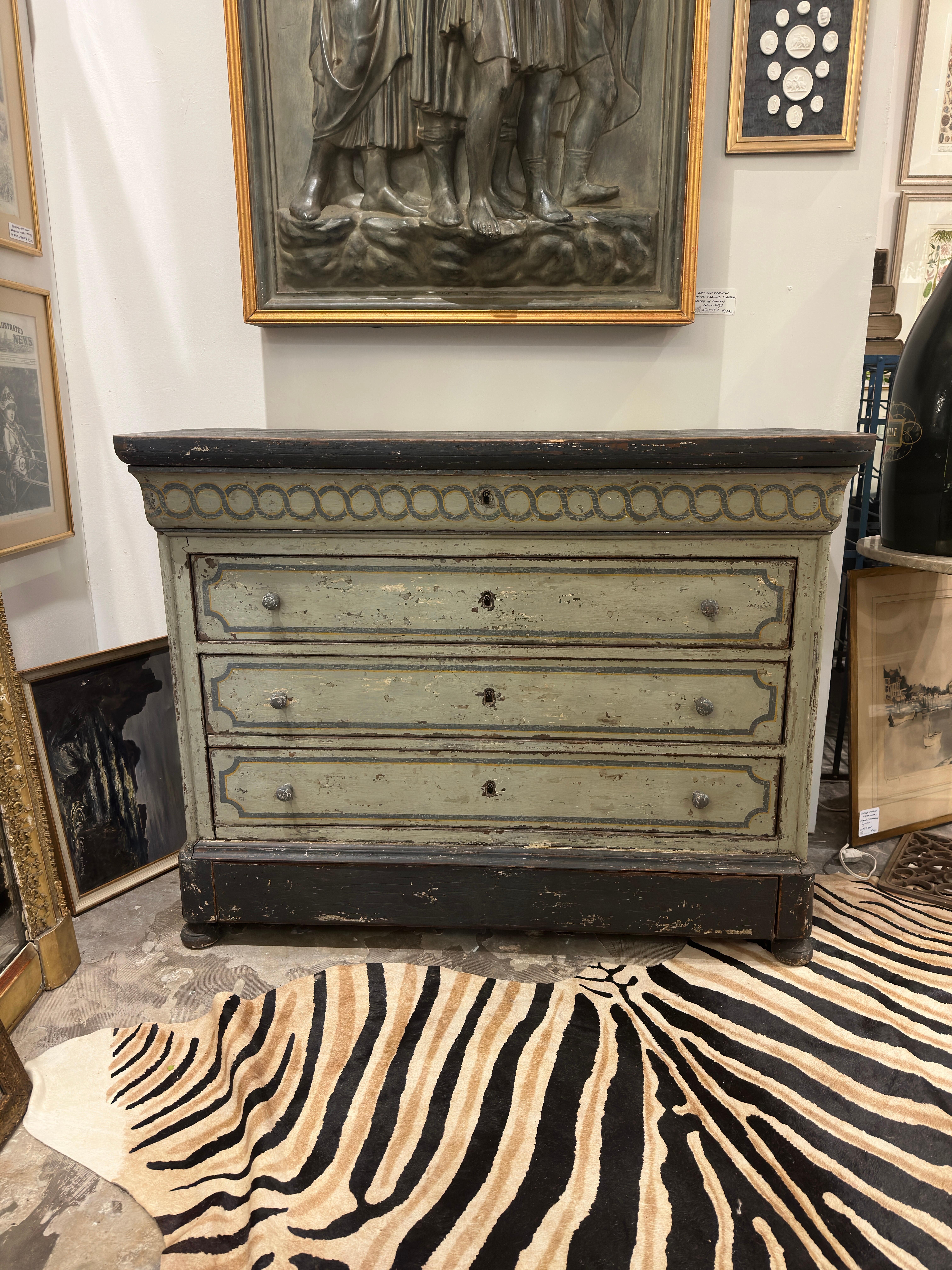 Antique French chest featuring exquisite painted grey detail with a distressed patina and five drawers. The first four drawers each include a working lock with key offering a large level of storage. Very sturdy piece crafted from French Oak and