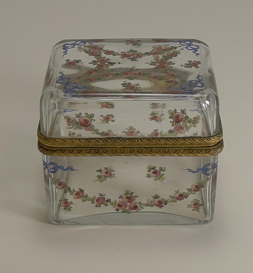An exquisite late 19th century French crystal box, pretty as a picture, hand painted with floral garlands tied with blue ribbon and bows.

The hinged fittings are made from gilded bronze, a signature by the maker stamped on the interior, A.