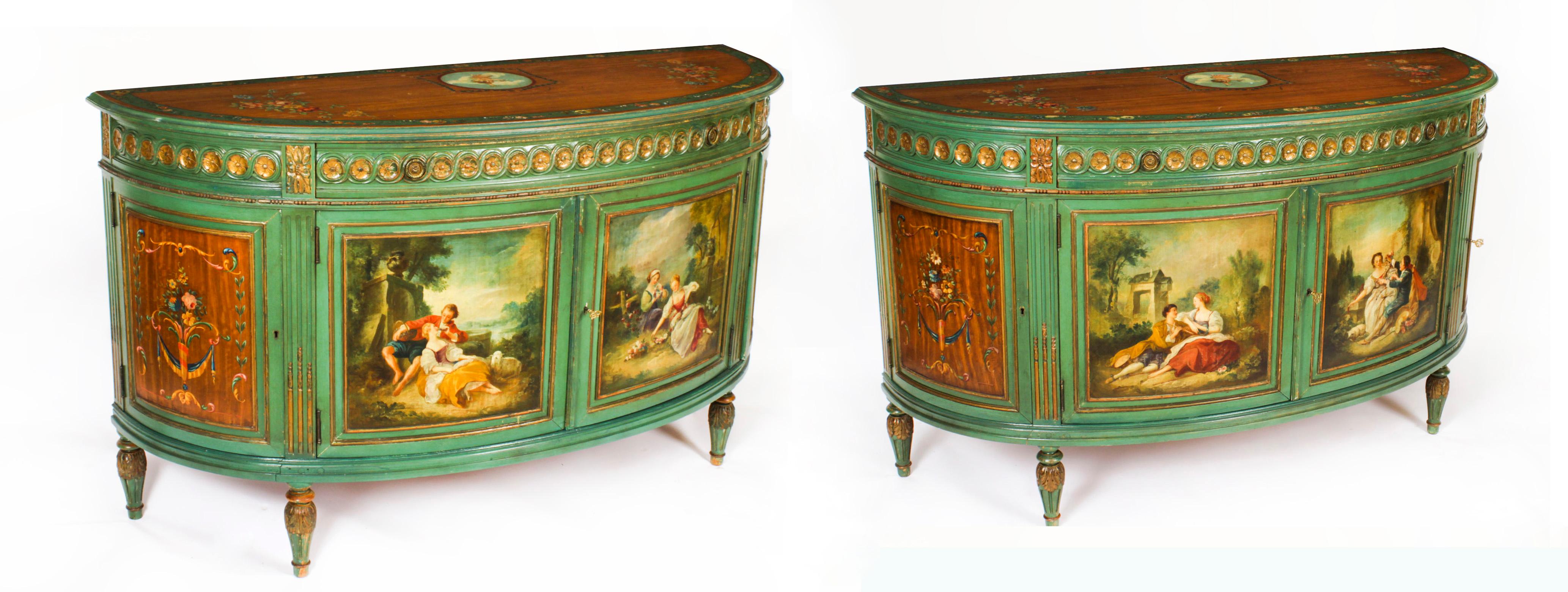 This is a gorgeous antique pair of antique French Louis XVI revival demi lune commodes with beautiful hand painted decoration in the manner of Francois Boucher,  Circa 1920 in date.
 
The half moon satin wood top of each commode features