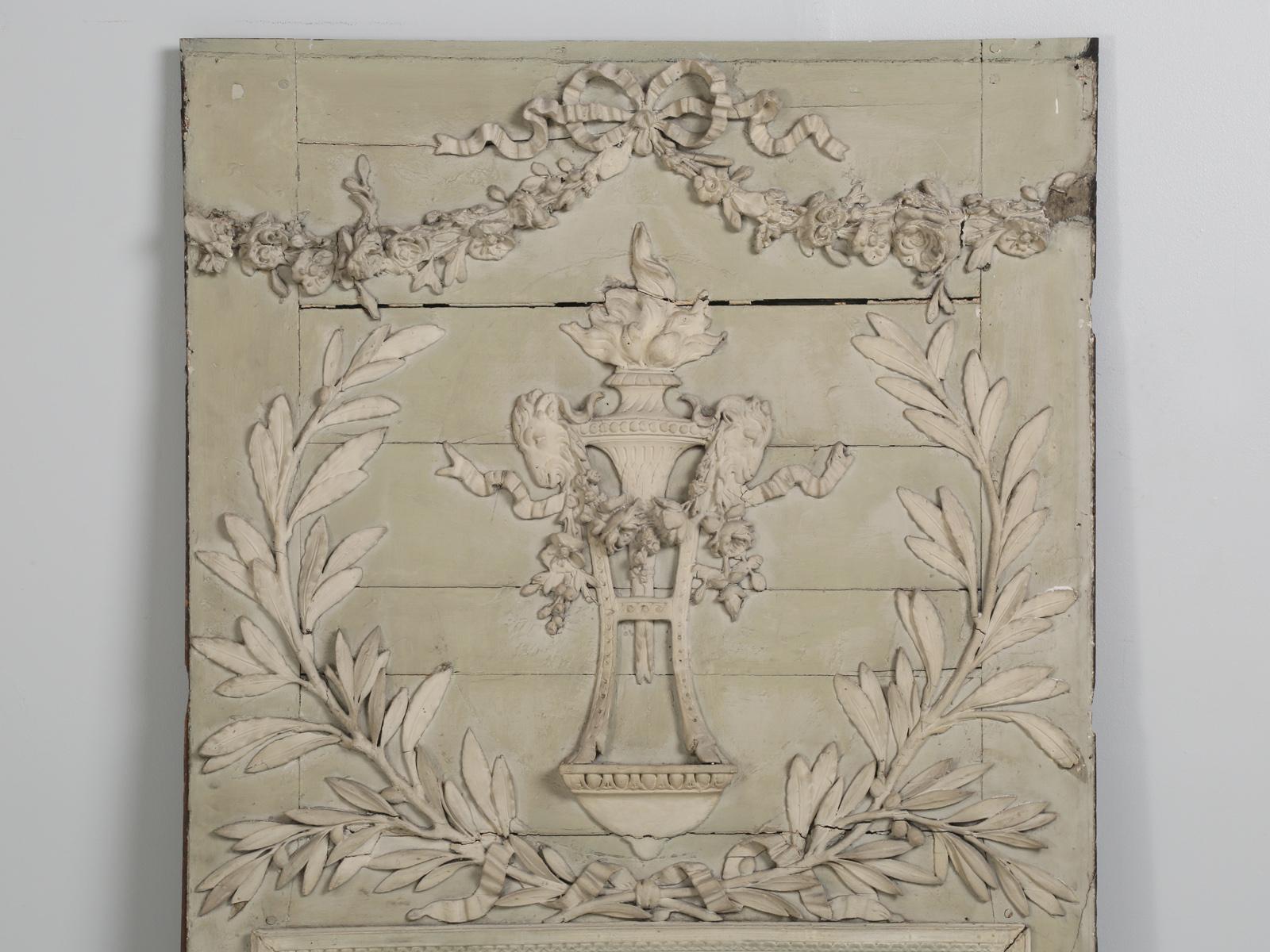 Antique French Mirror, in very Old Paint and probably made in the mid-1800's. Beautiful and intricate hand-carved relief, consisting of an urn flanked by pair of rams, floras, and leaves. Built into an early Parisian apartment. Painted in a soft and