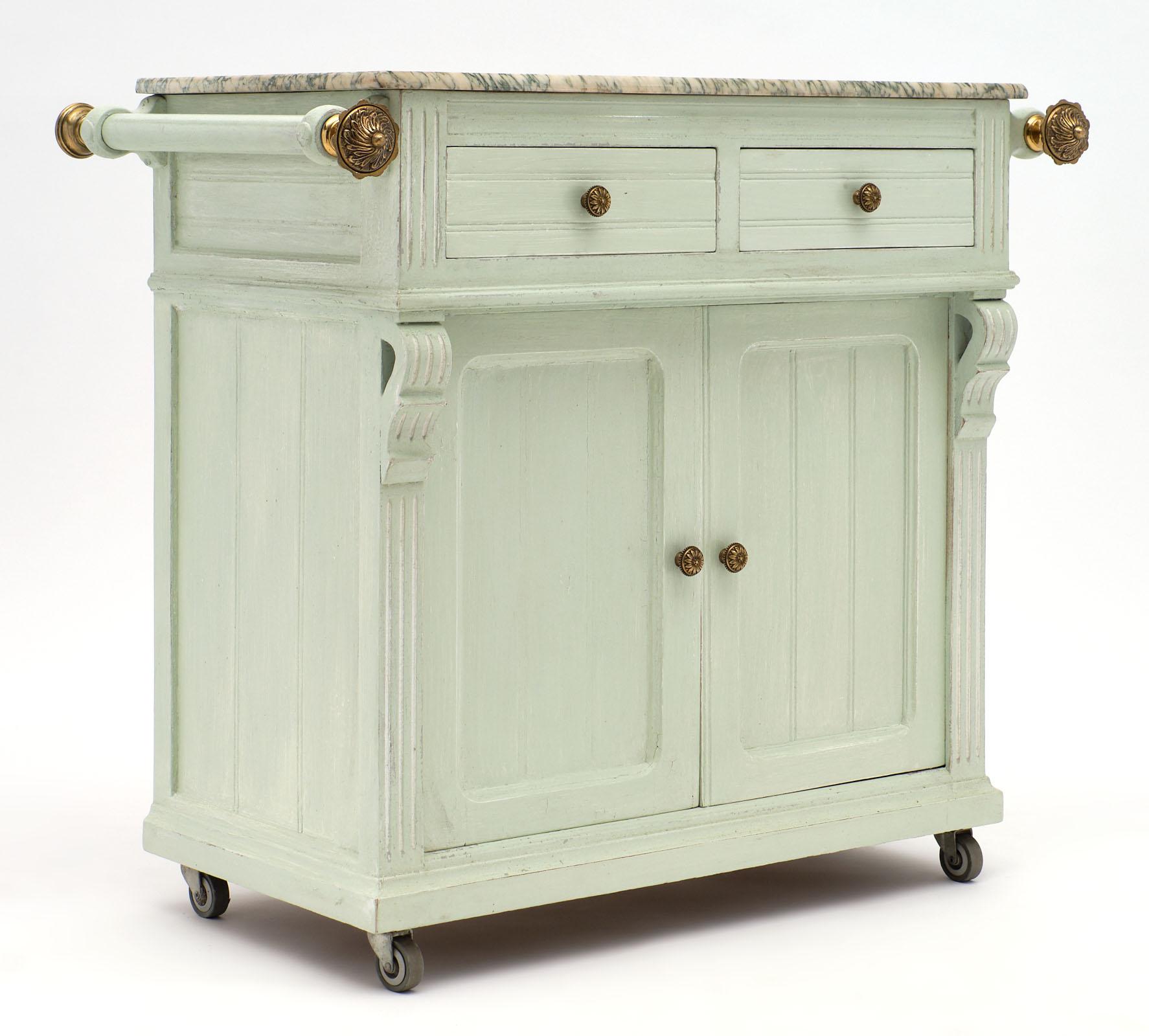 French antique painted pastry cabinet made of fir with the original “aqua verde” marble top and side handle bars featuring finely cast bronze finials. We love the tightness of the piece and the storage inside. Two drawers give extra storage and the