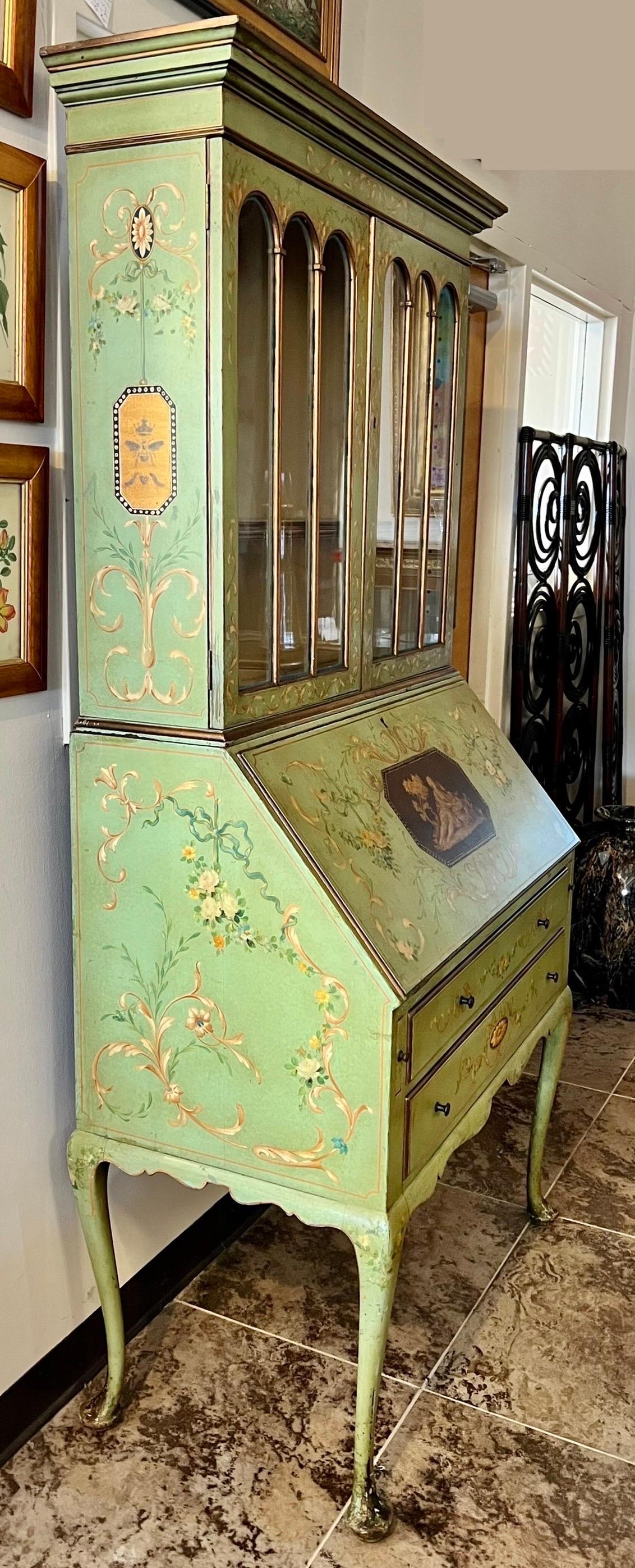 Exquisite antique French hand-painted 2 part drop front secretary desk display cabinet. Features beautiful hand-painted floral and ribbon detail all around. Sides feature hand painted bees.
Top part has glass doors that open to shelving. (Note that